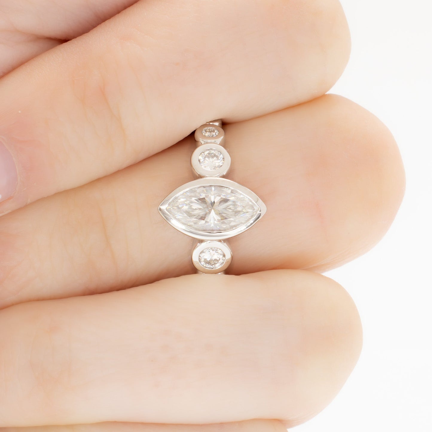 Aisha bezel set engagement ring with white moissanite marquise