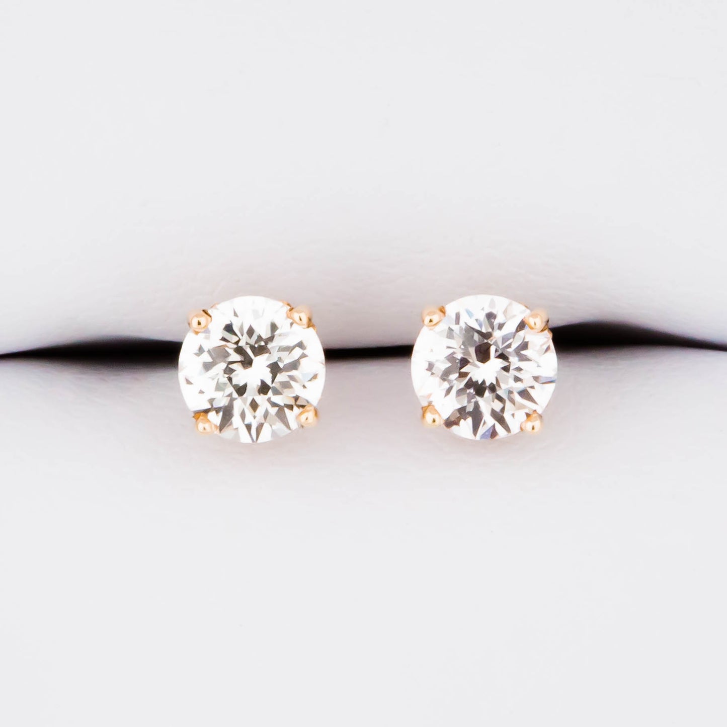 white lab sapphire earrings in yellow gold