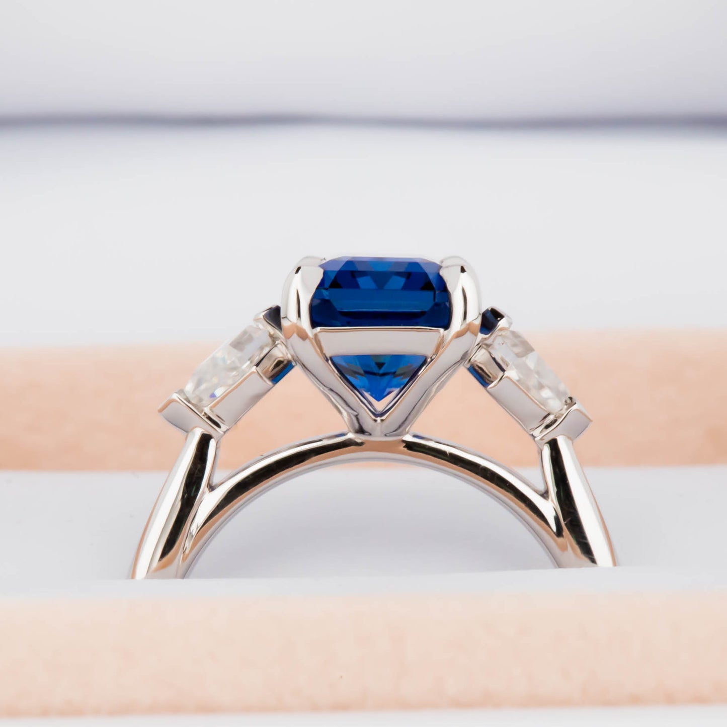 Jamie three stone engagement ring with step cut lab sapphire