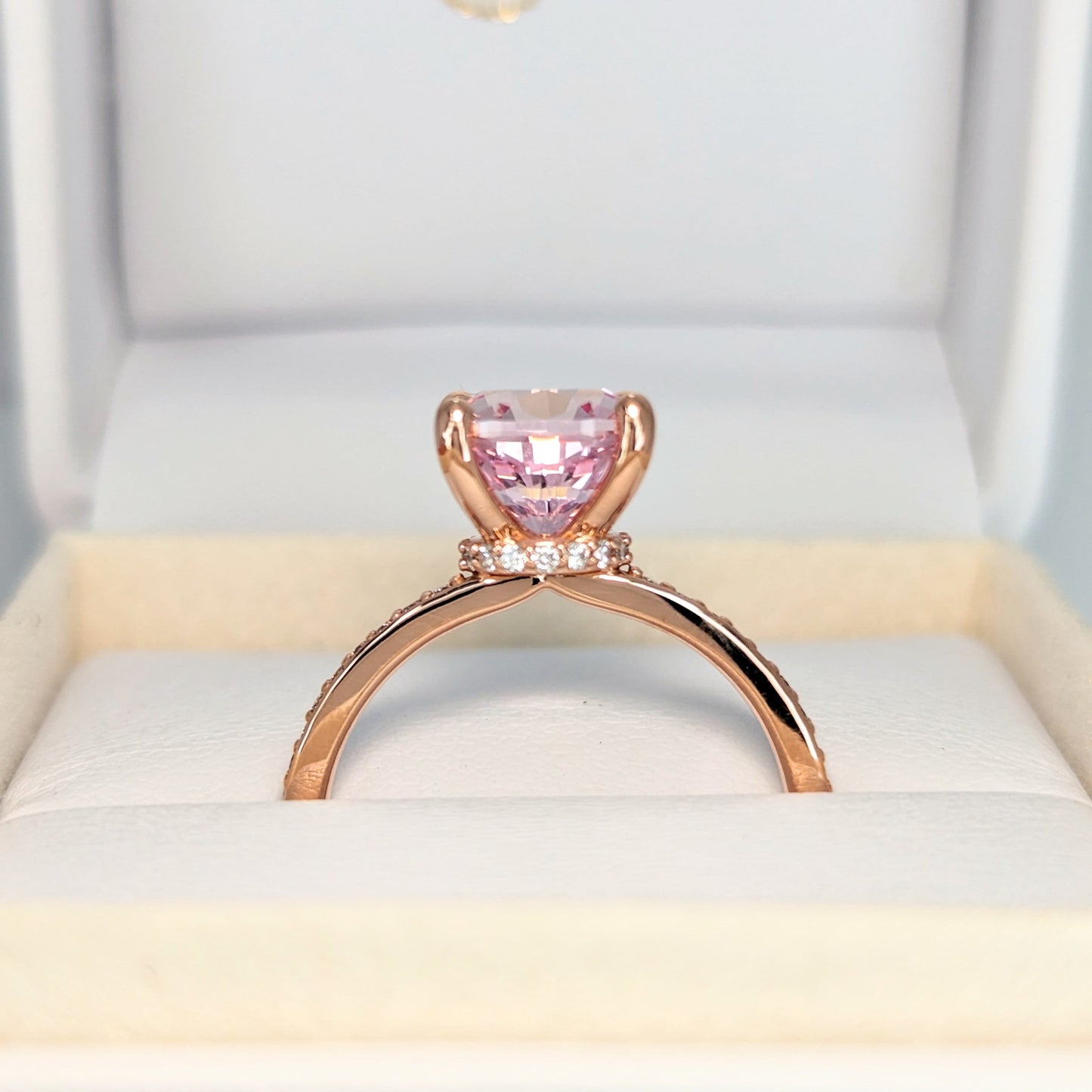 Kira hidden halo engagement ring with peach lab sapphire cushion