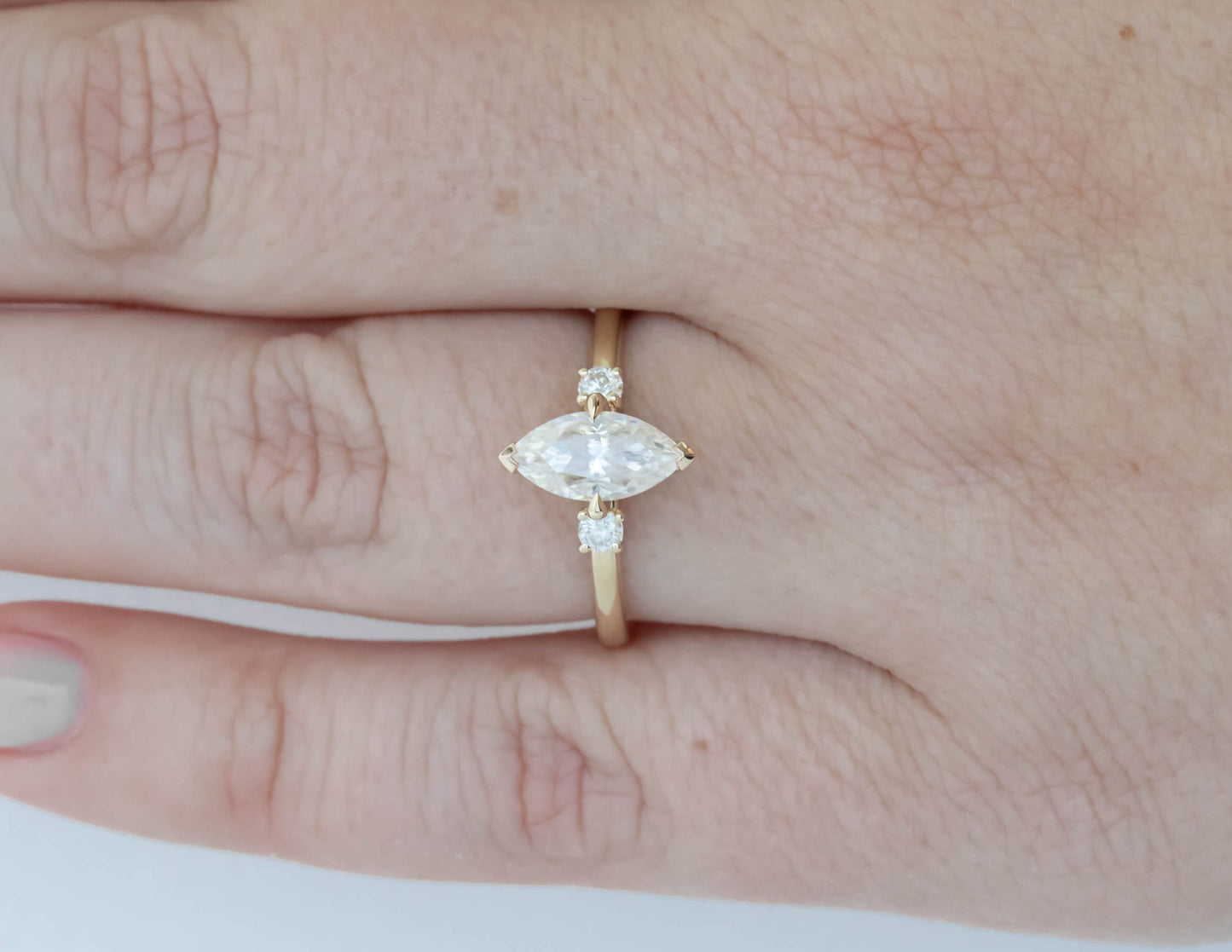 yellow gold 3 stone ring with moissanite marquise