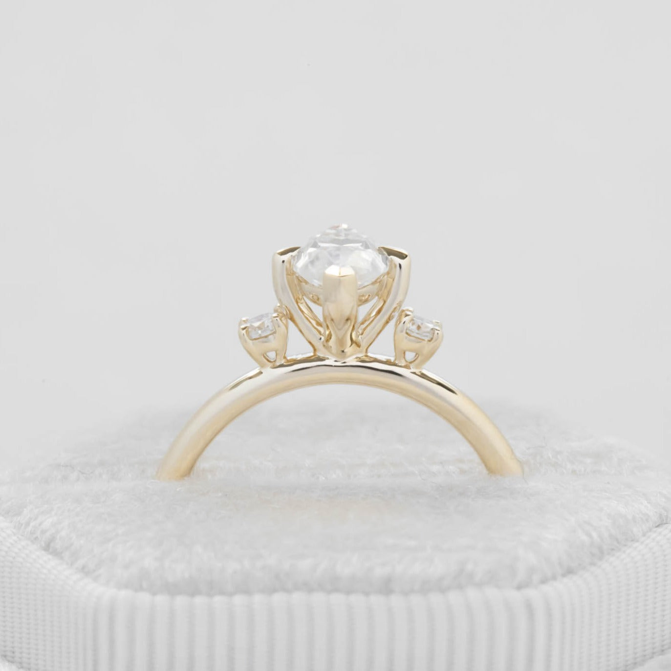 yellow gold 3 stone ring with moissanite marquise