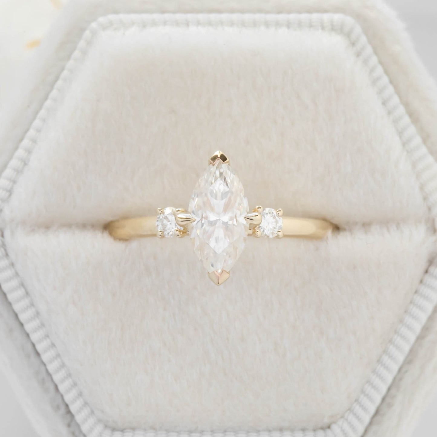 yellow gold 3 stone ring with moissanite marquise
