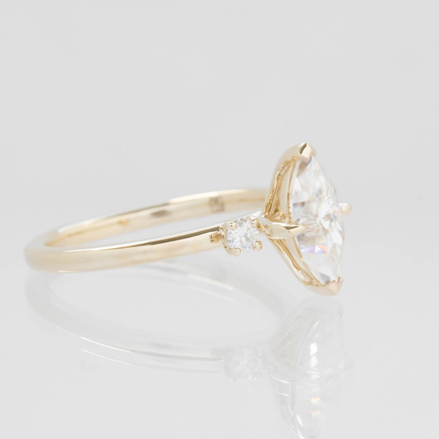 yellow gold 3 stone ring with moissanite marquise