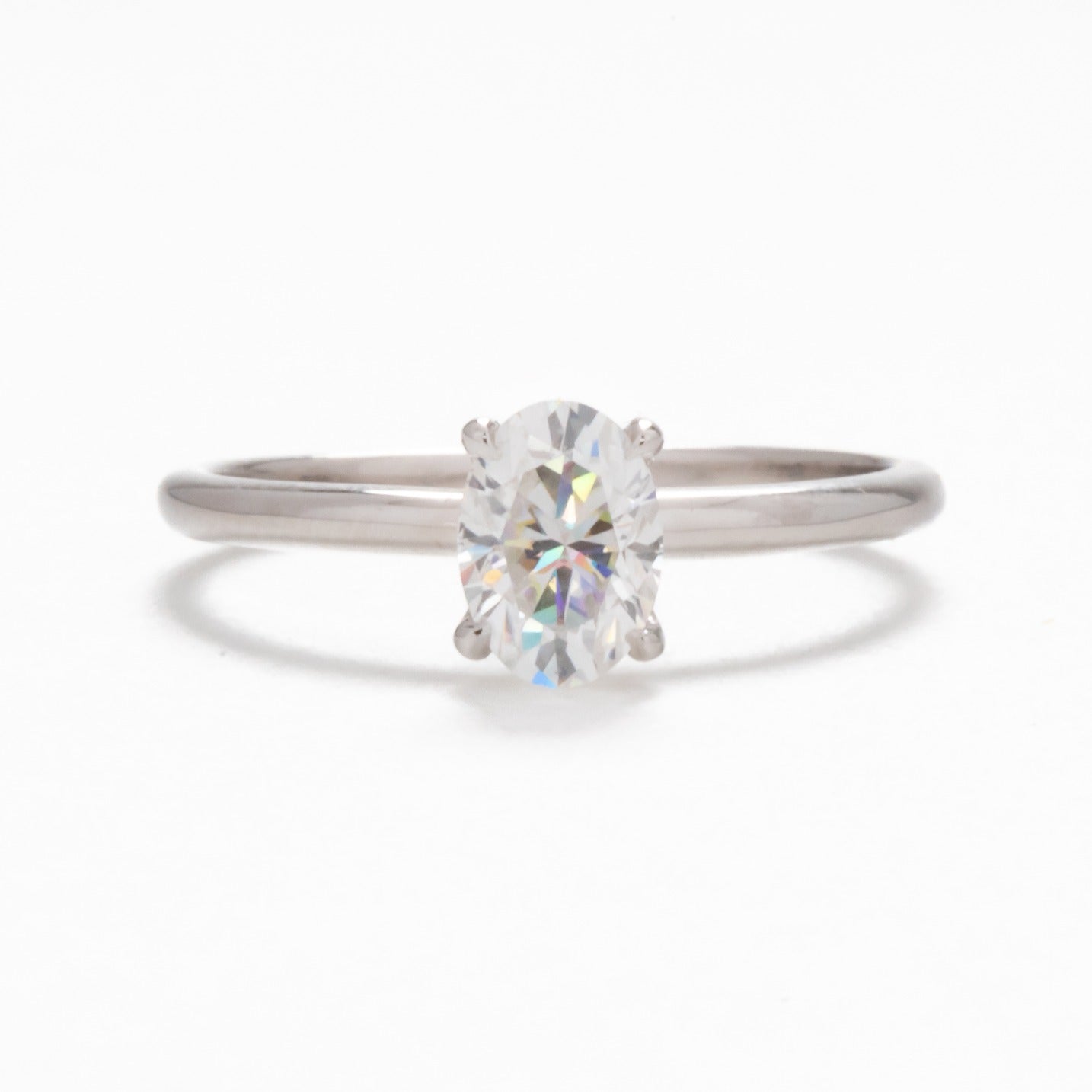 Petite oval solitaire engagement ring with moissanite