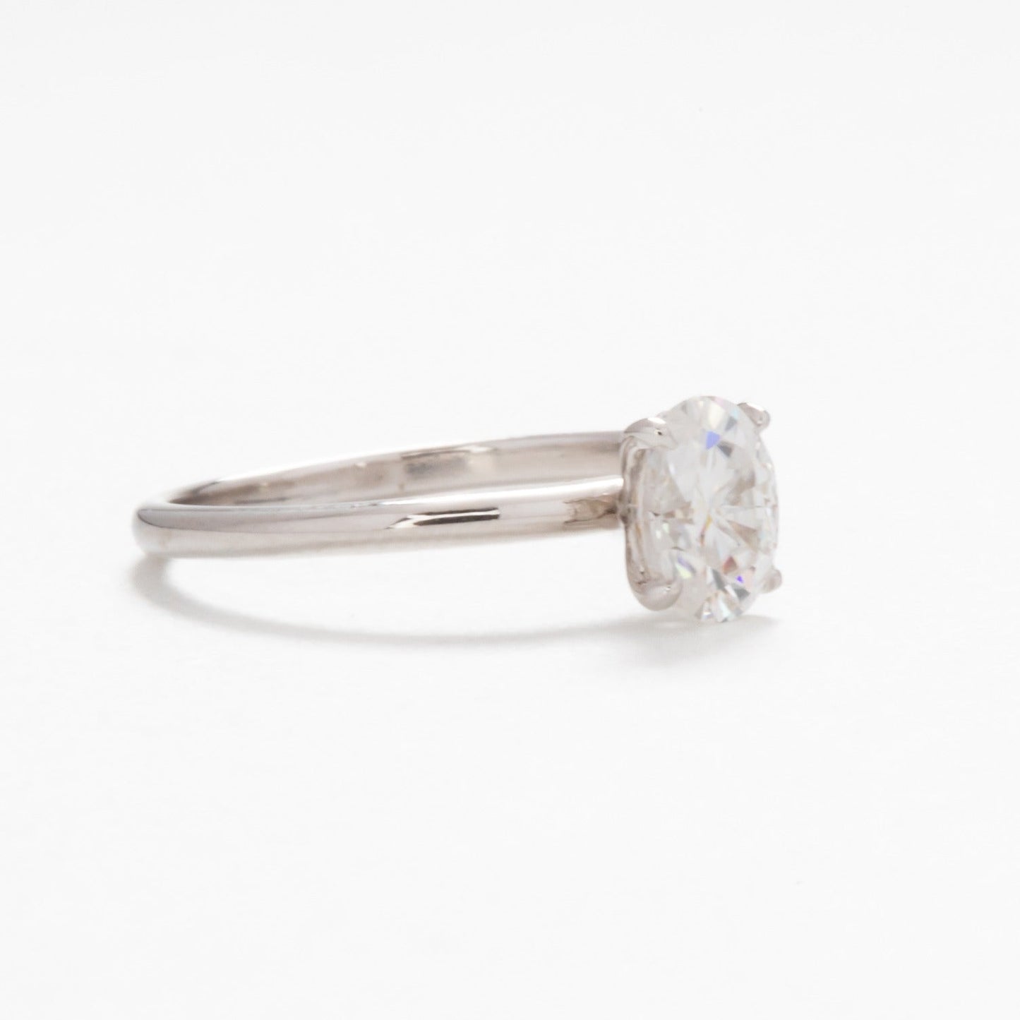 Petite oval solitaire engagement ring with moissanite