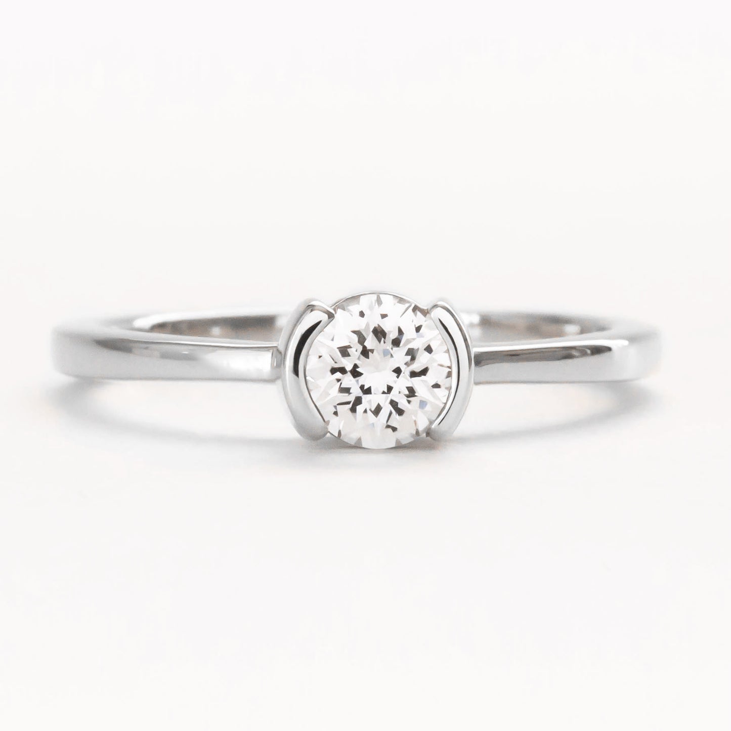 Reese half bezel solitaire engagement ring with lab sapphire