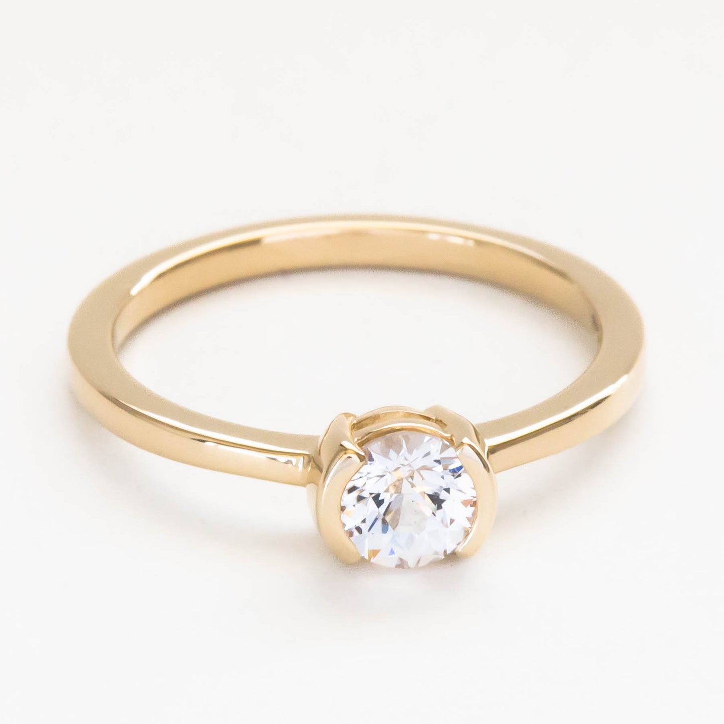 Reese half bezel solitaire engagement ring with lab sapphire