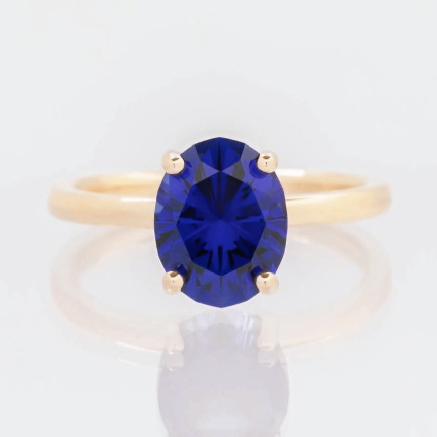 Serene solitaire engagement ring with oval blue lab sapphire