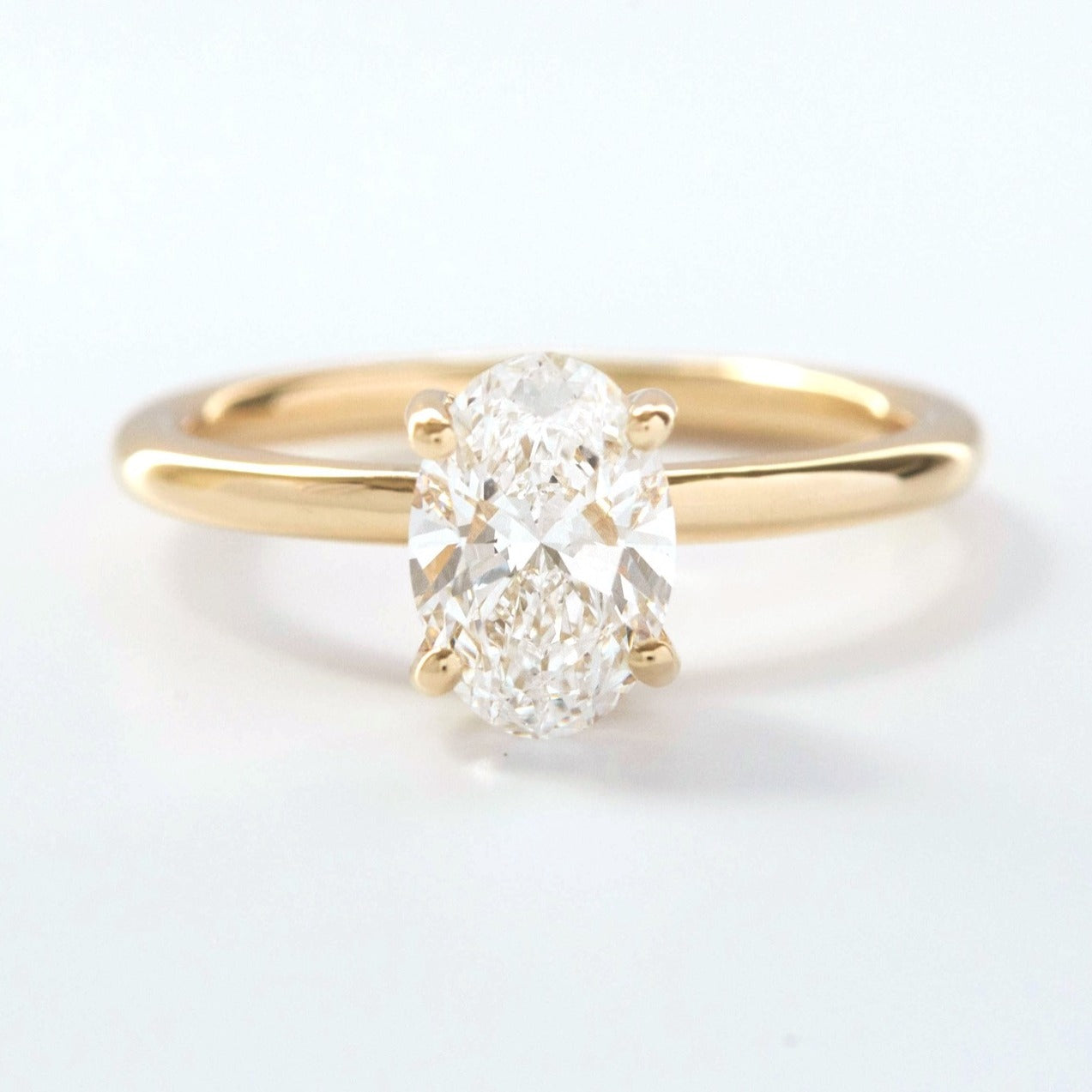 Serene solitaire engagement ring with oval lab sapphire