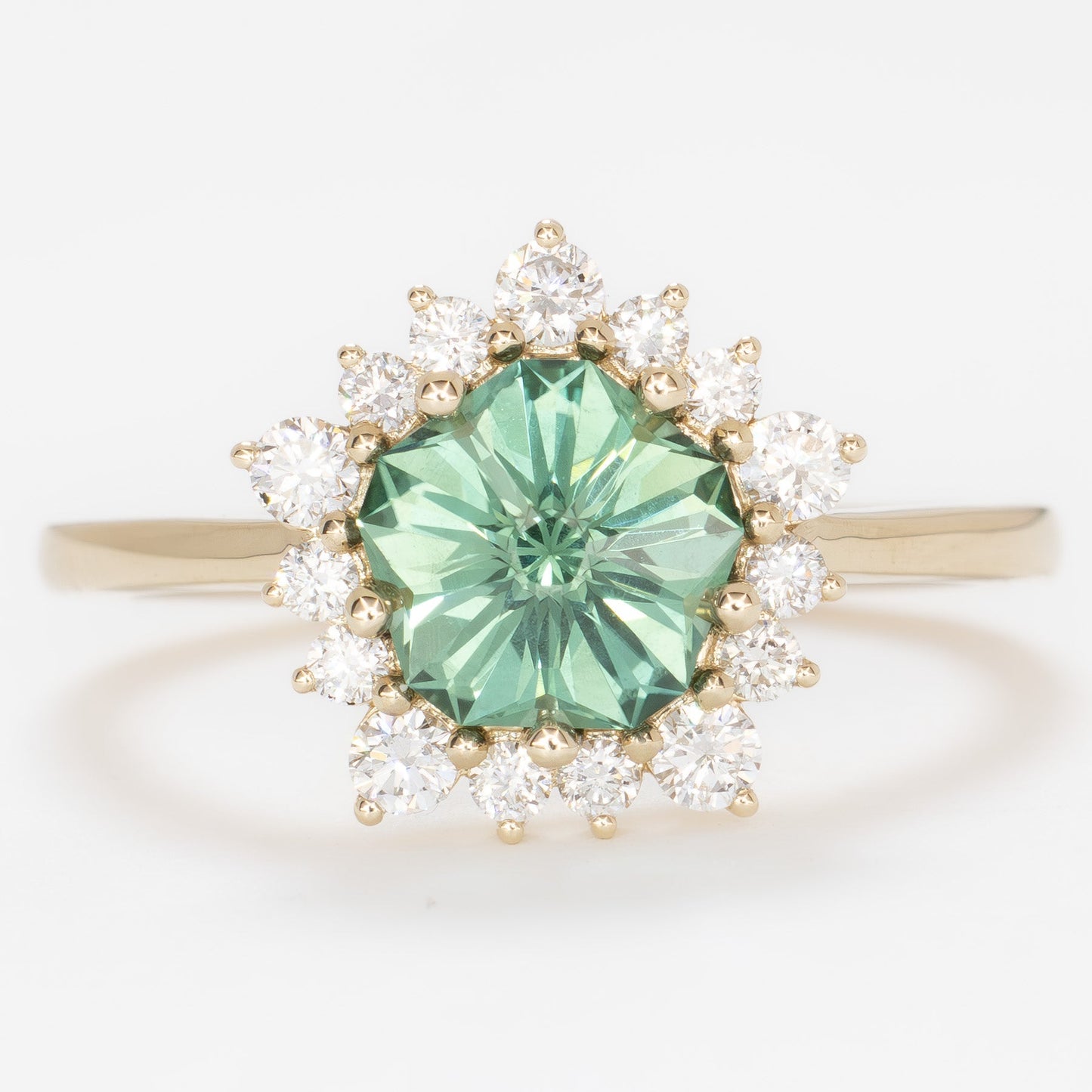aurora snowflake inspired halo engagement ring with a green lab sapphire hanami pentagon