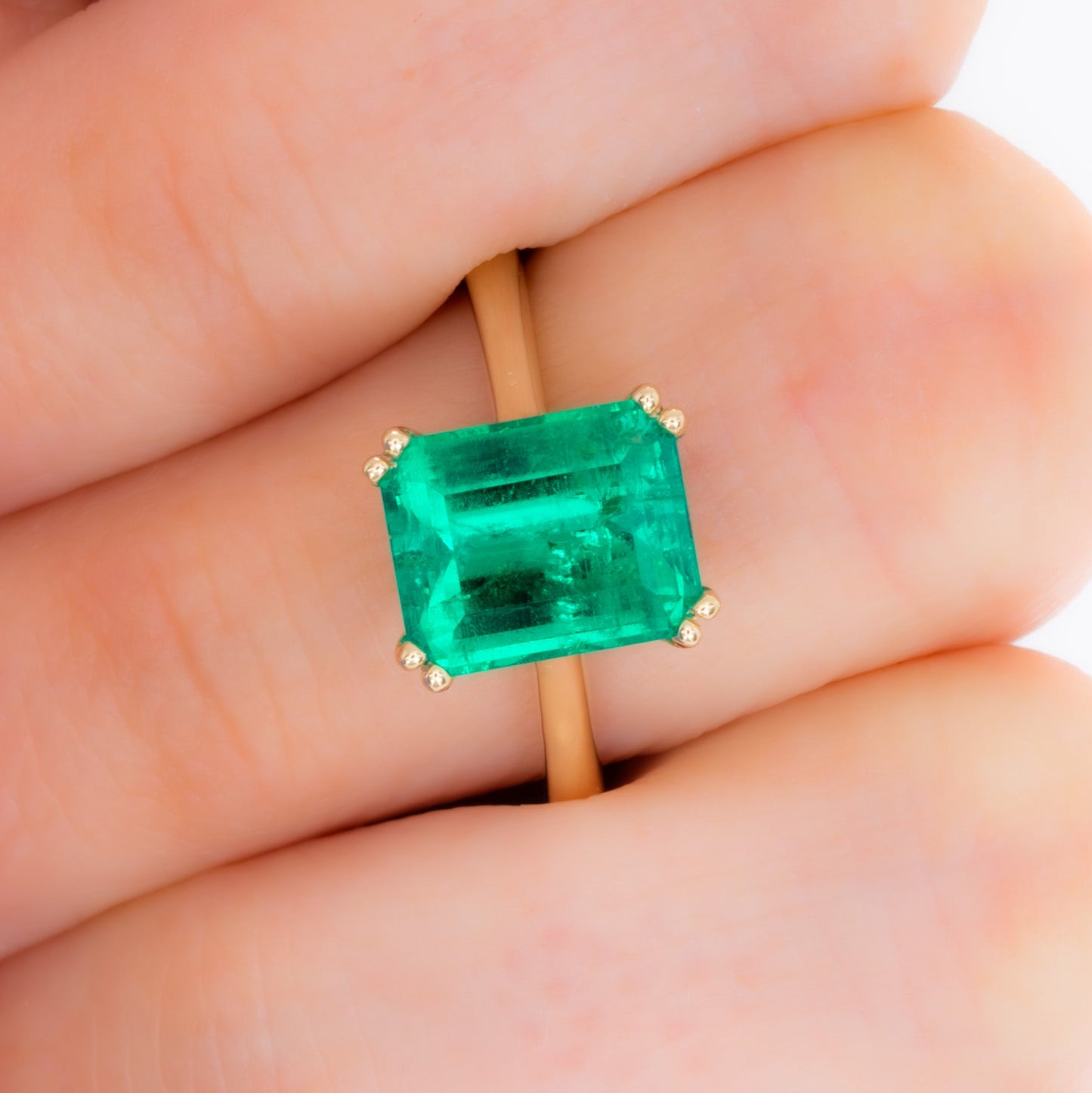 bailey solitaire ring in yellow gold with step cut lab emerald