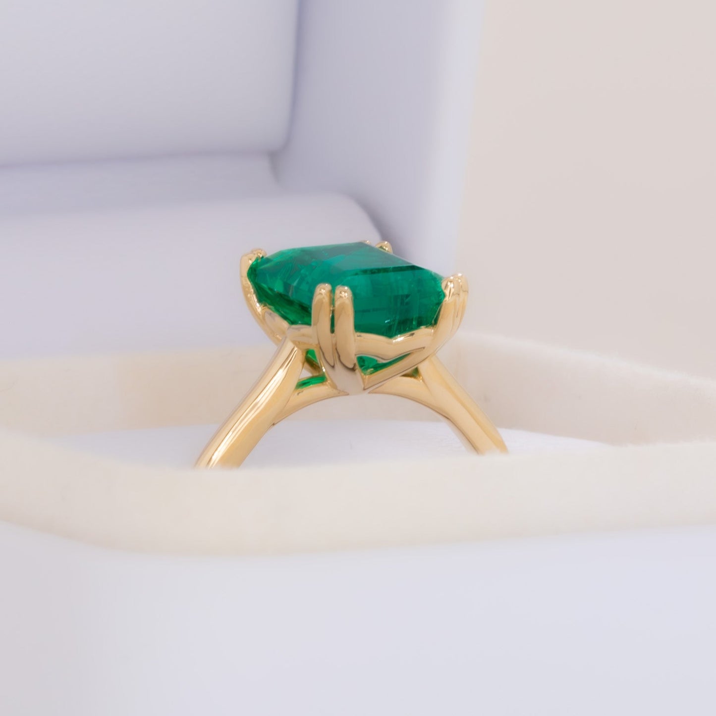 bailey solitaire ring in yellow gold with step cut lab emerald