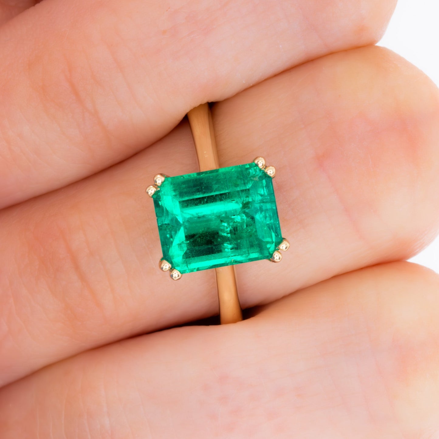 bailey solitaire ring in yellow gold with step cut lab emerald