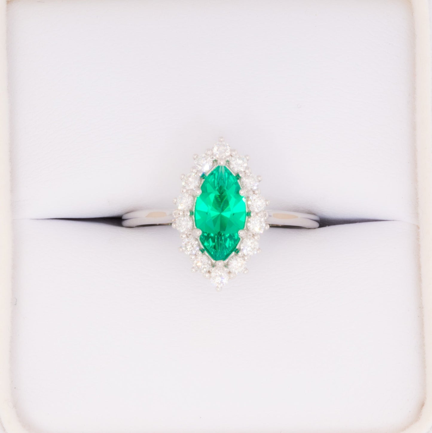 calypso halo engagement ring in white gold and marquise lab emerald