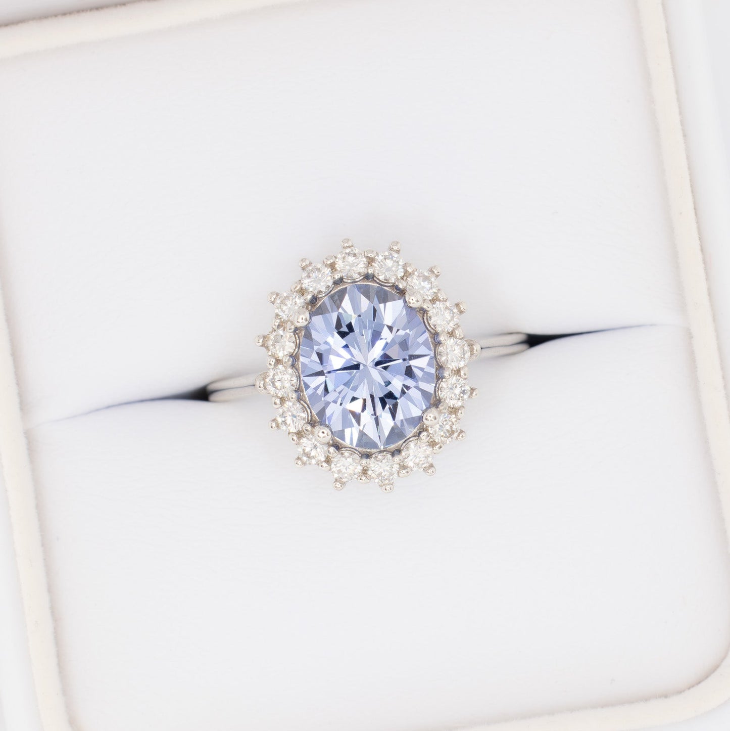 calypso halo engagement ring with oval blue lab sapphire