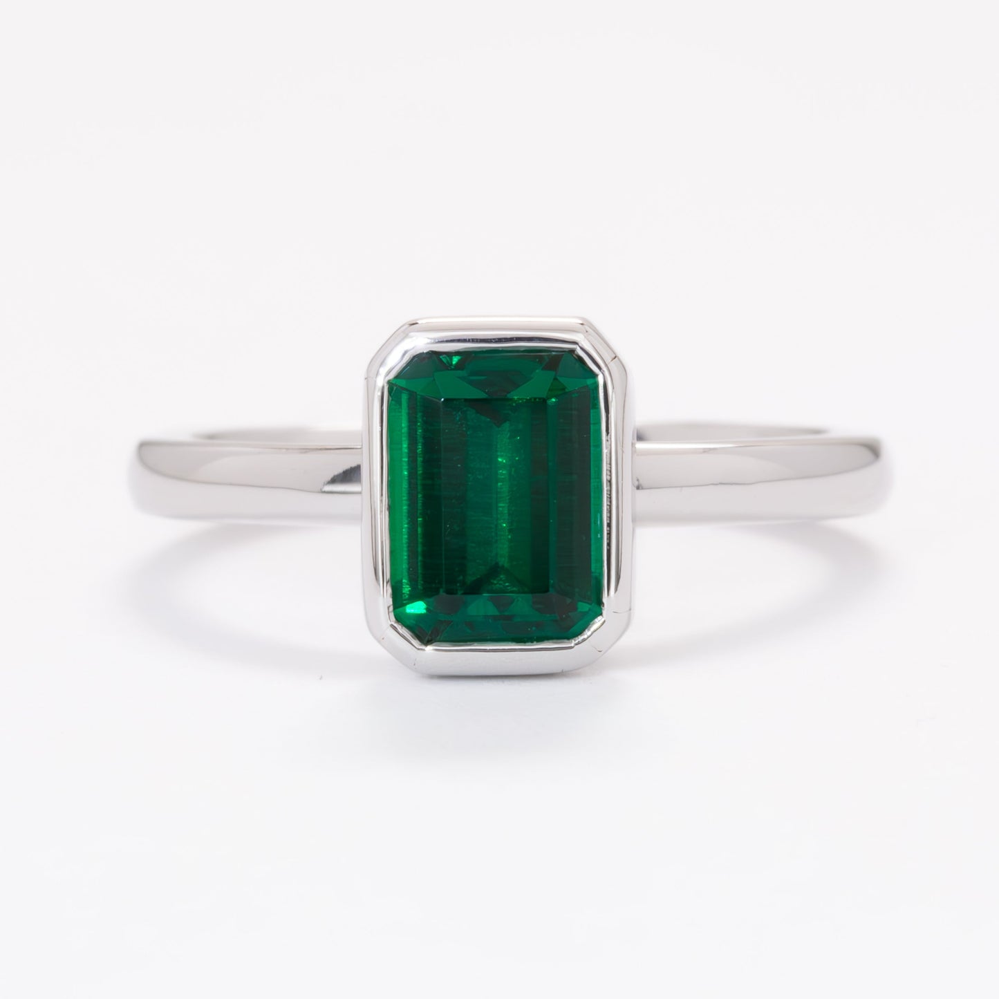 cami engagement ring with lab emerald step cut