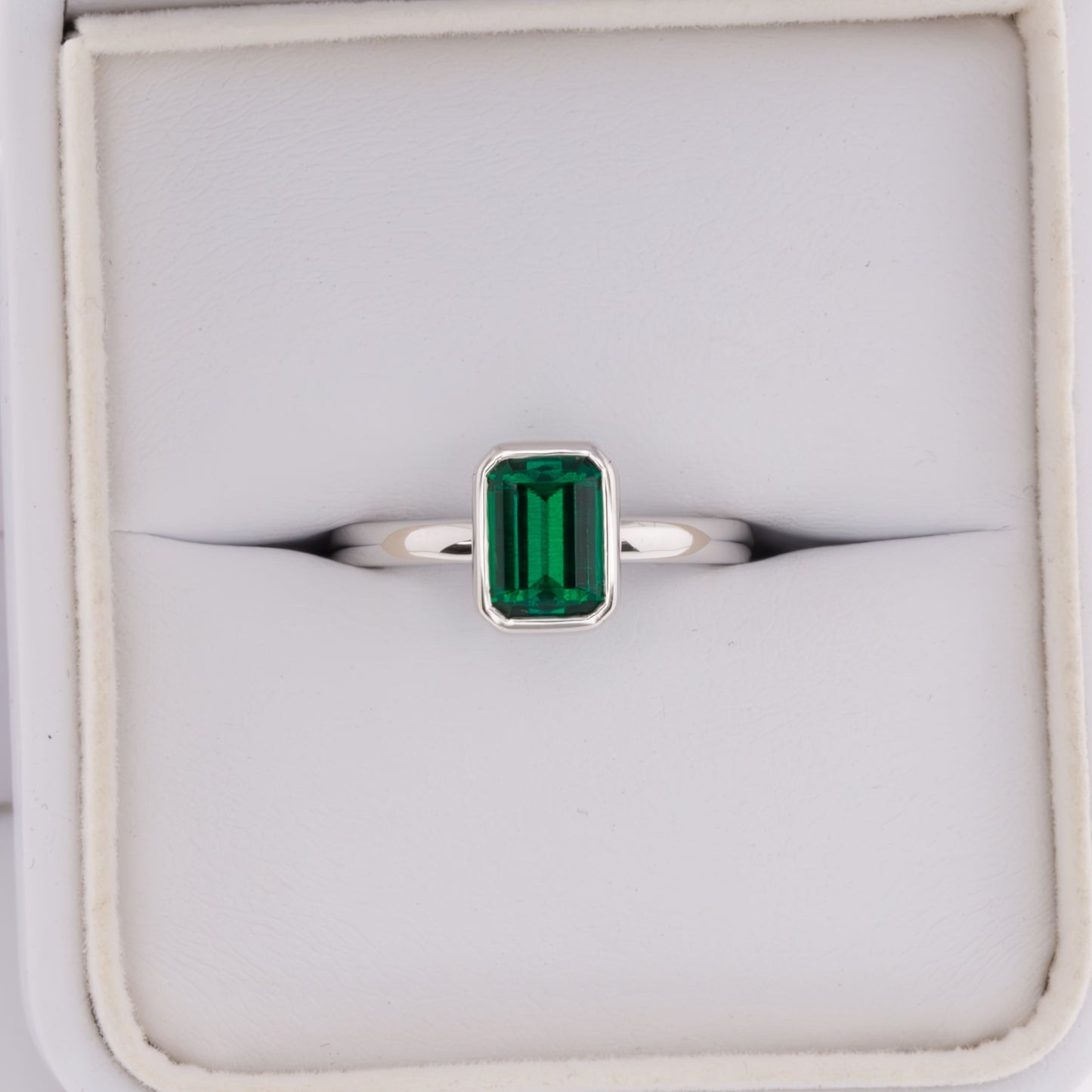 cami engagement ring with lab emerald step cut