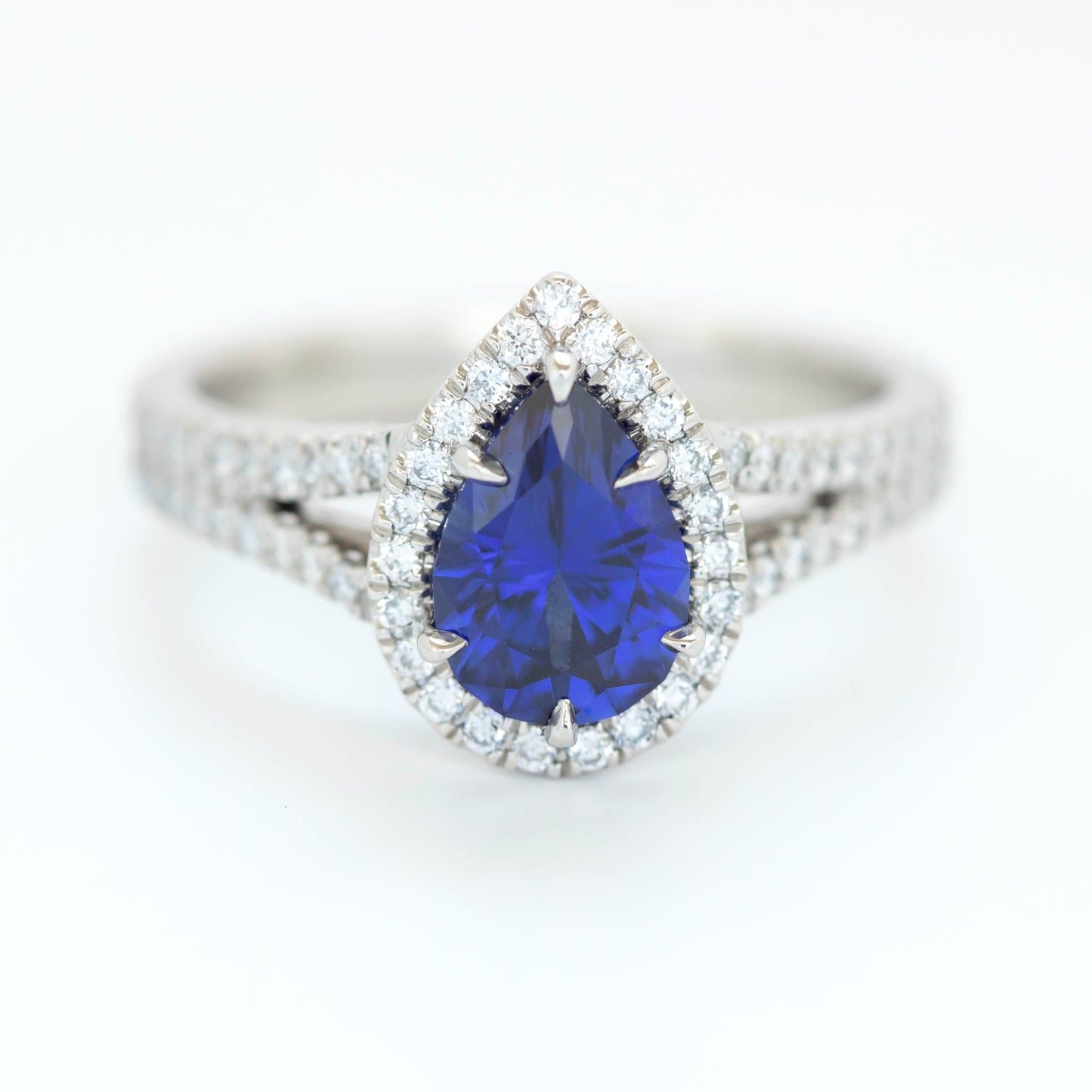 cove halo engagement ring with blue lab sapphire pear