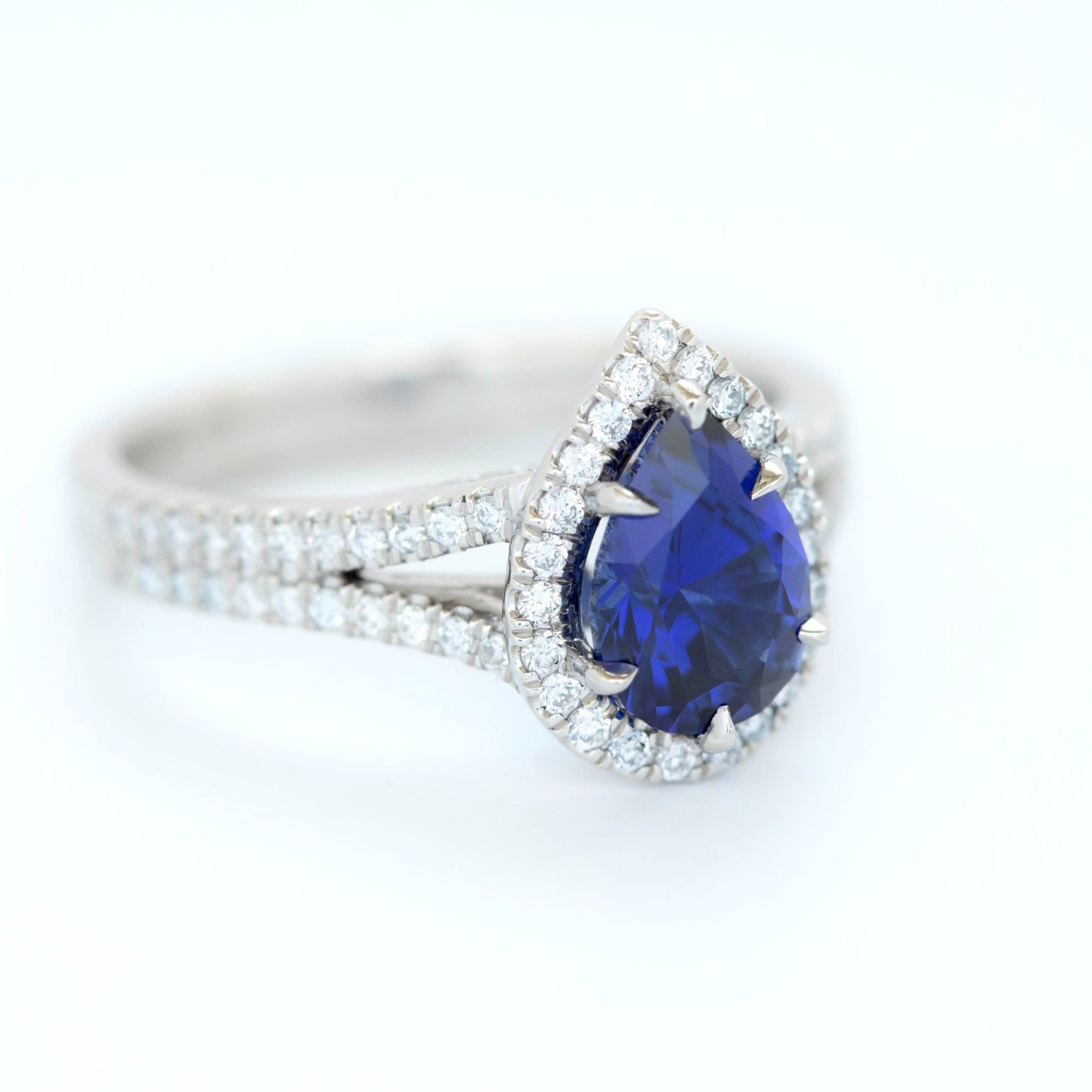 cove halo engagement ring with blue lab sapphire pear