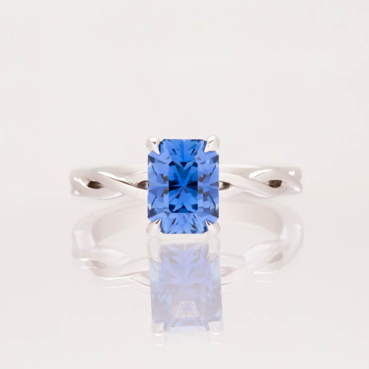 cressida engagement ring with twisted band and radiant lab sapphire