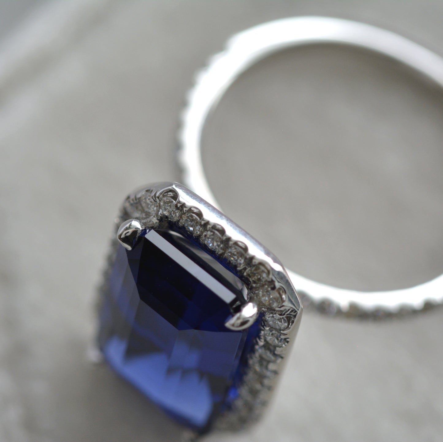large blue step cut lab sapphire ring with halo