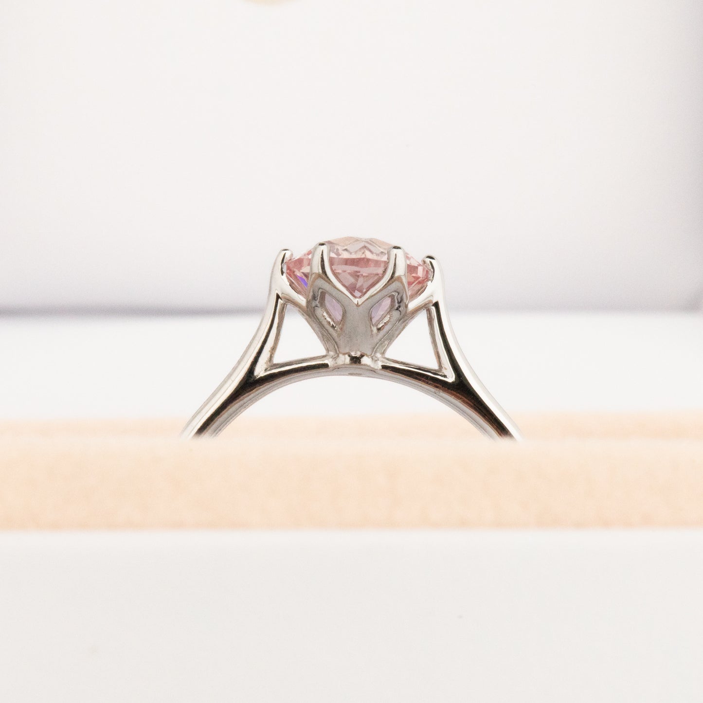 daphnis engagement ring with peach lab sapphire