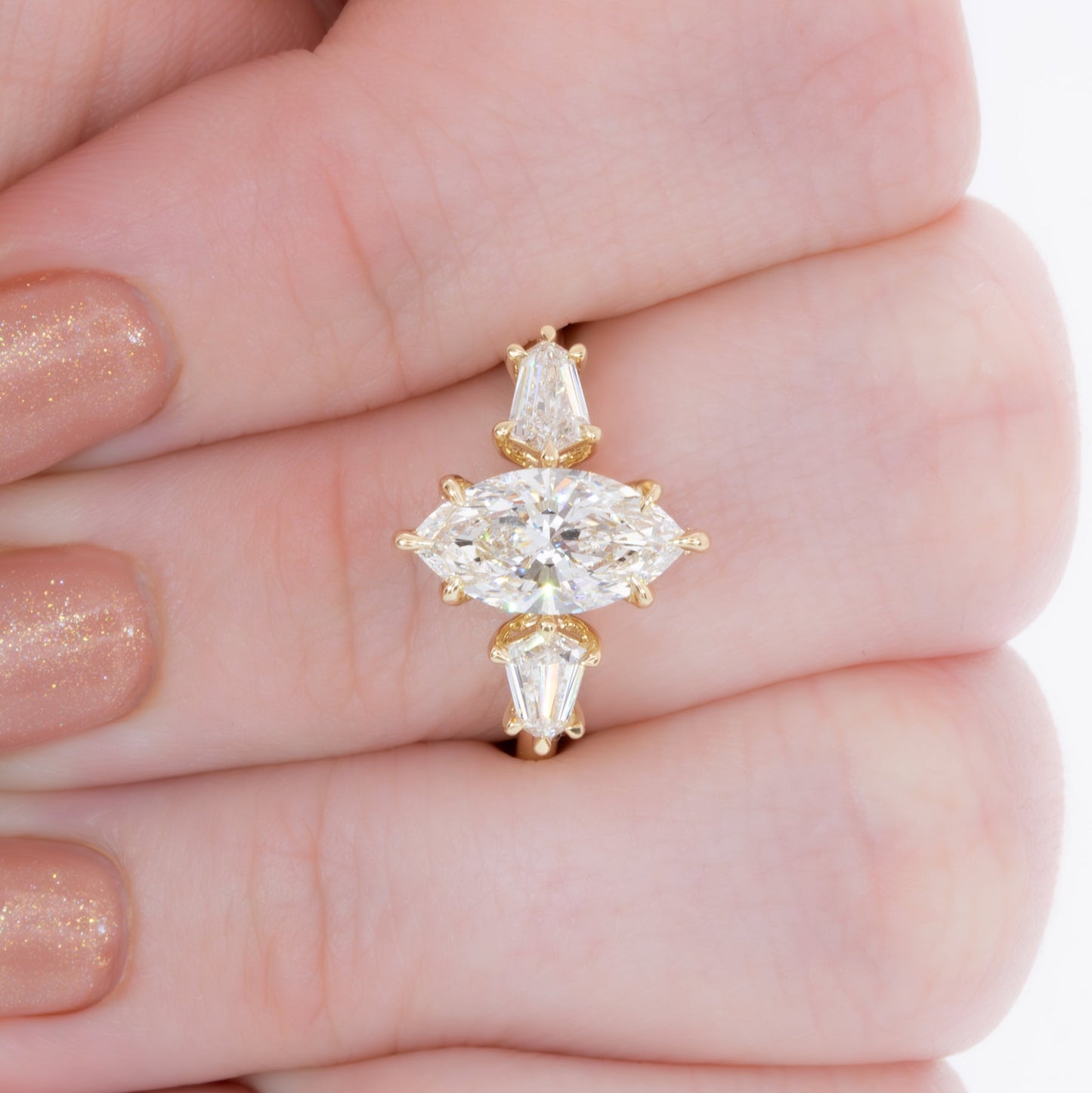 felicity three stone engagement ring with marquise lab diamond