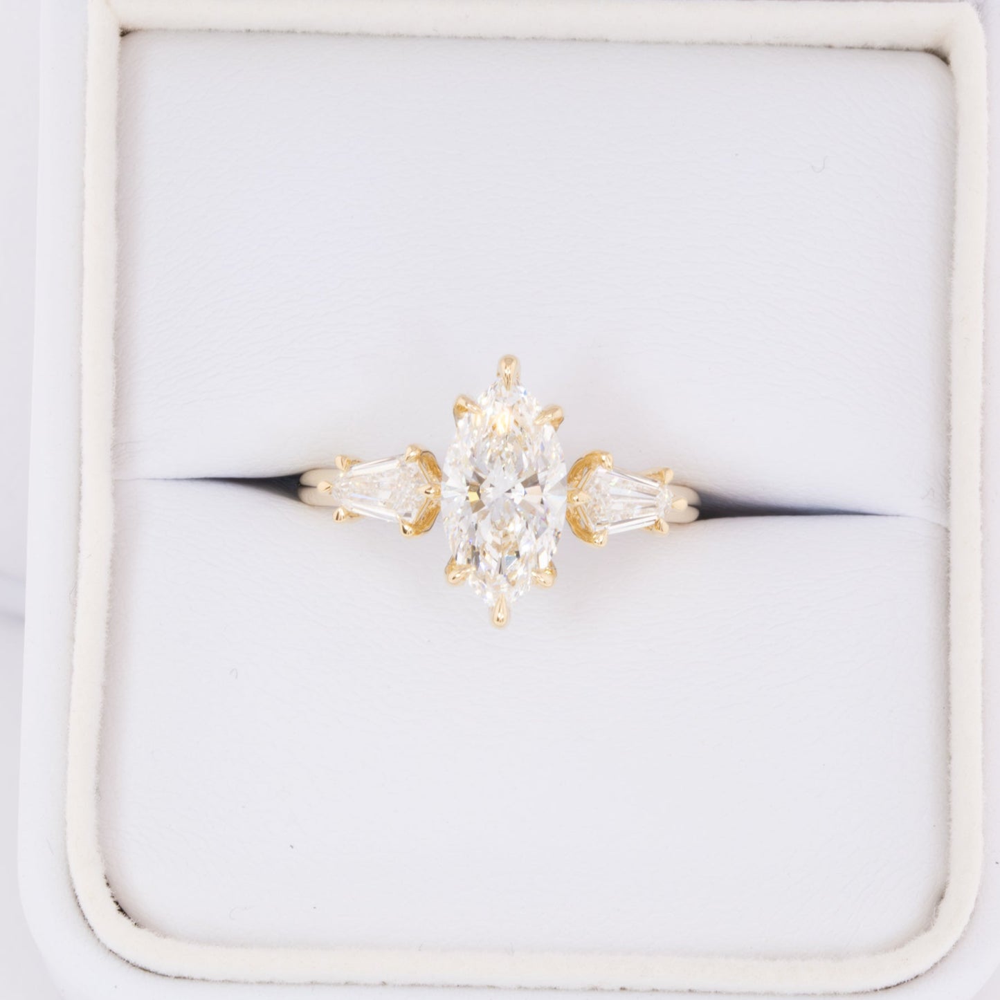 felicity three stone engagement ring with marquise lab diamond