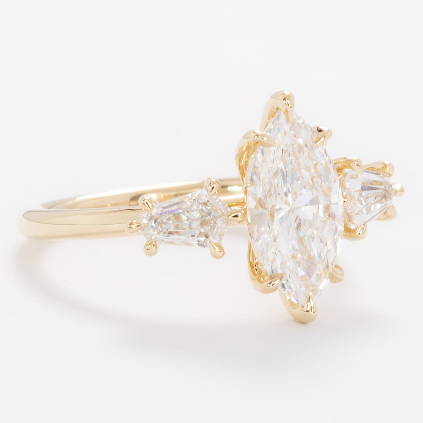 felicity three stone engagement ring with marquise lab diamond
