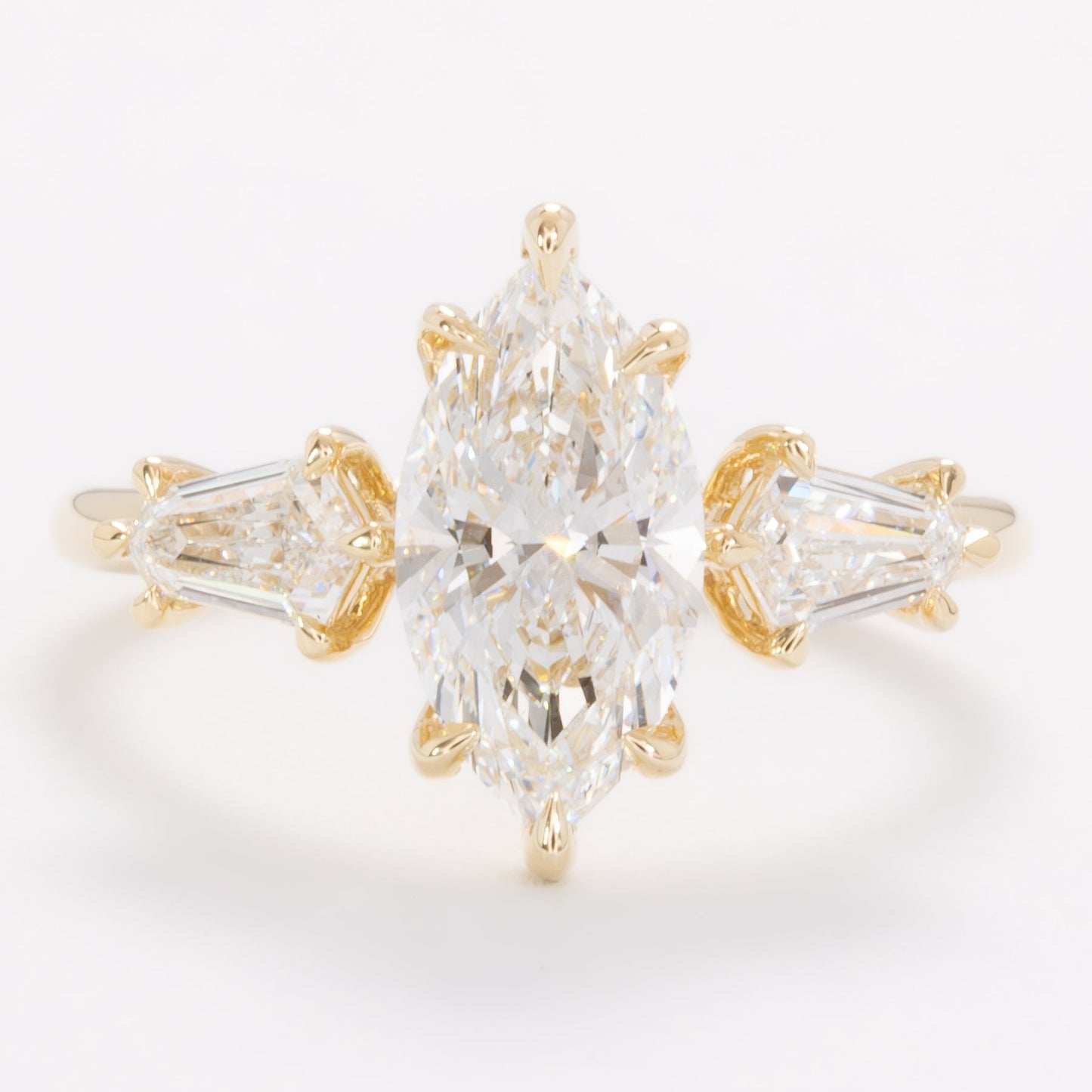 felicity three stone engagement ring with marquise lab diamond
