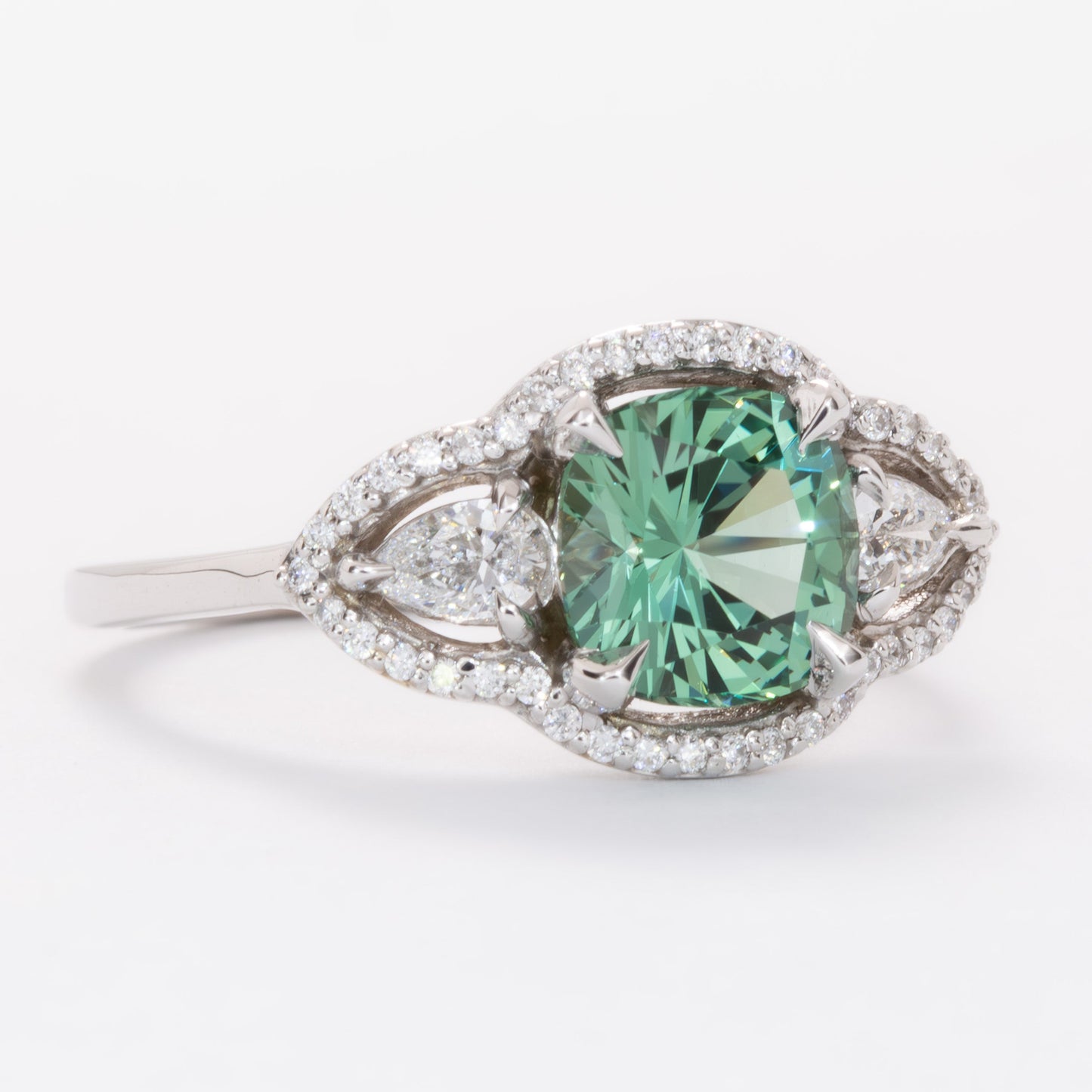 gayle three stone halo engagement ring with cushion green lab sapphire