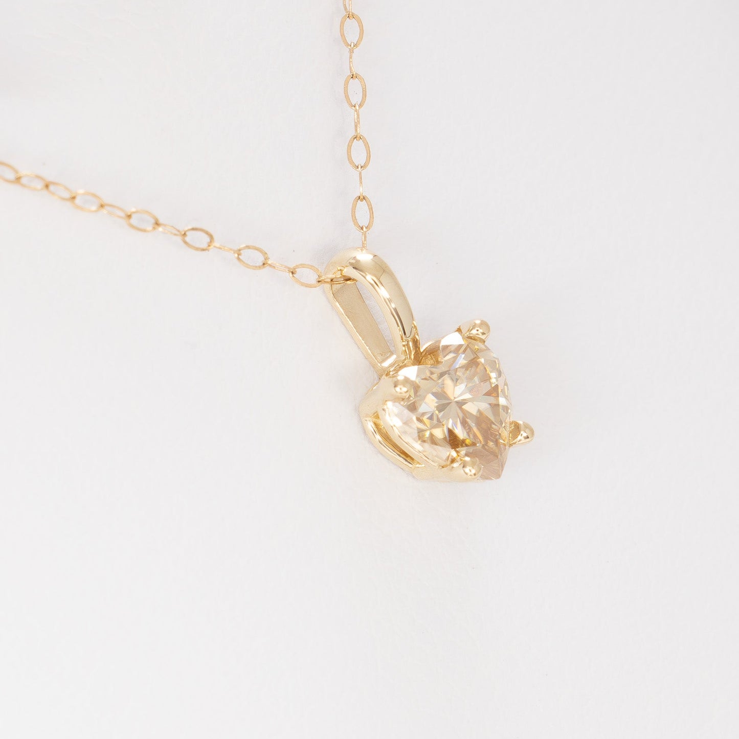 heart necklace in yellow gold with heart champagne moissanite