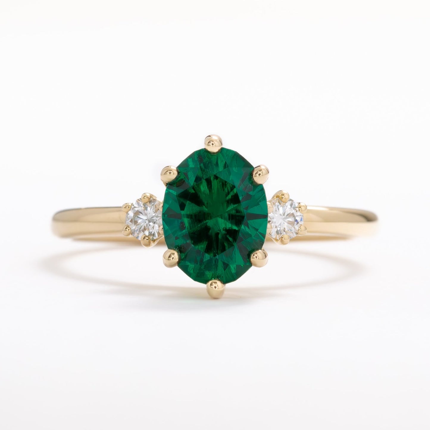 lab emerald oval three stone engagement ring