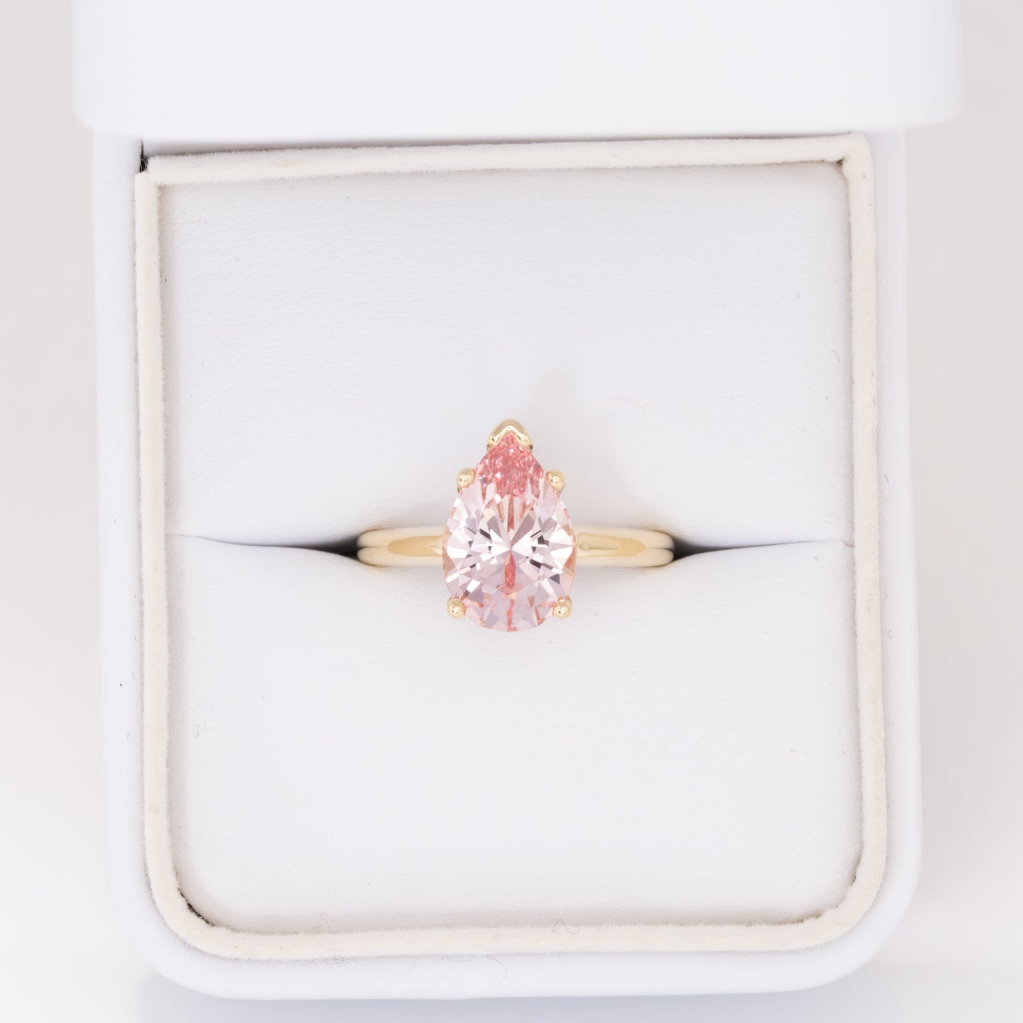 liv solitaire ring with peach lab sapphire pear