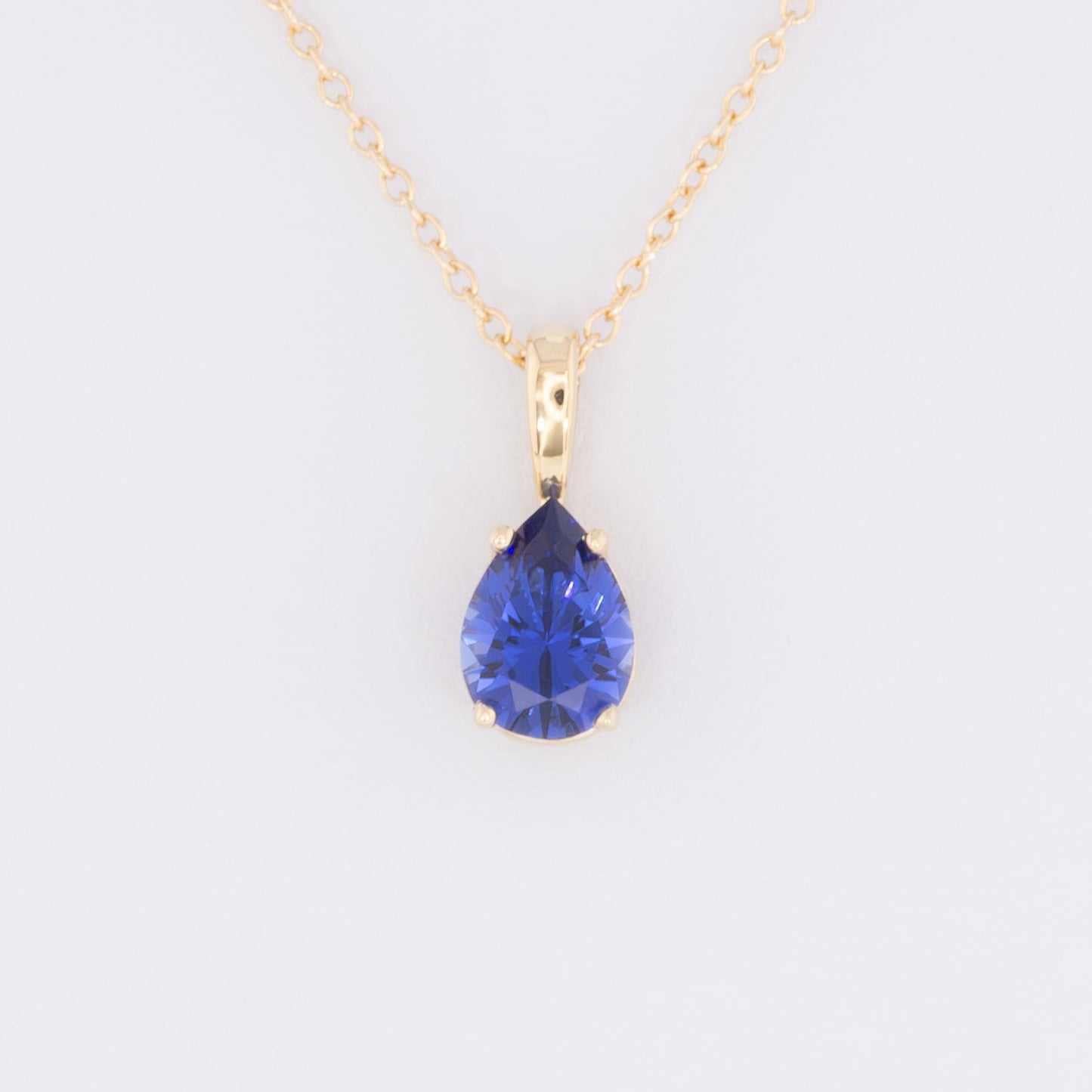 marley necklace in yellow gold and royal blue pear lab sapphire