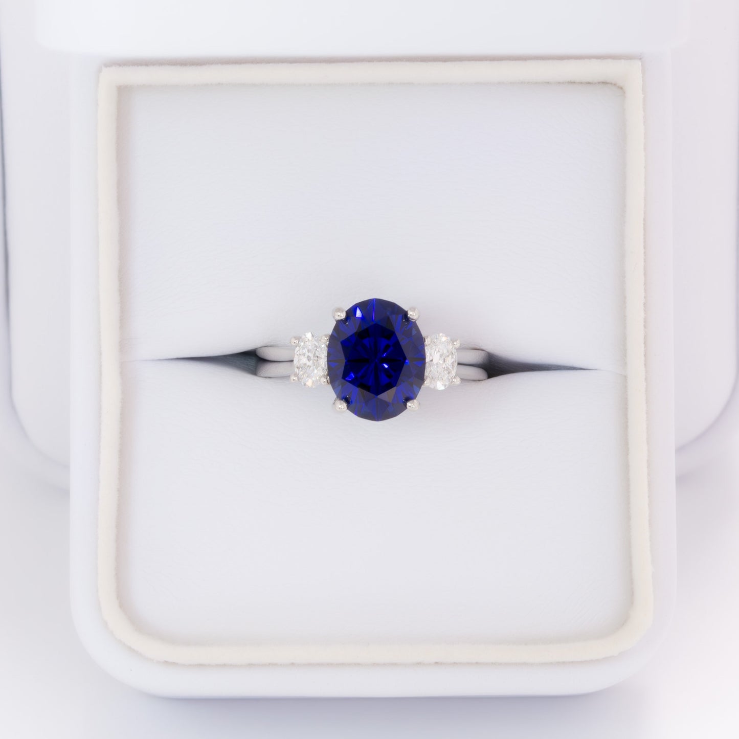 milly three stone engagement ring with oval royal blue lab sapphire