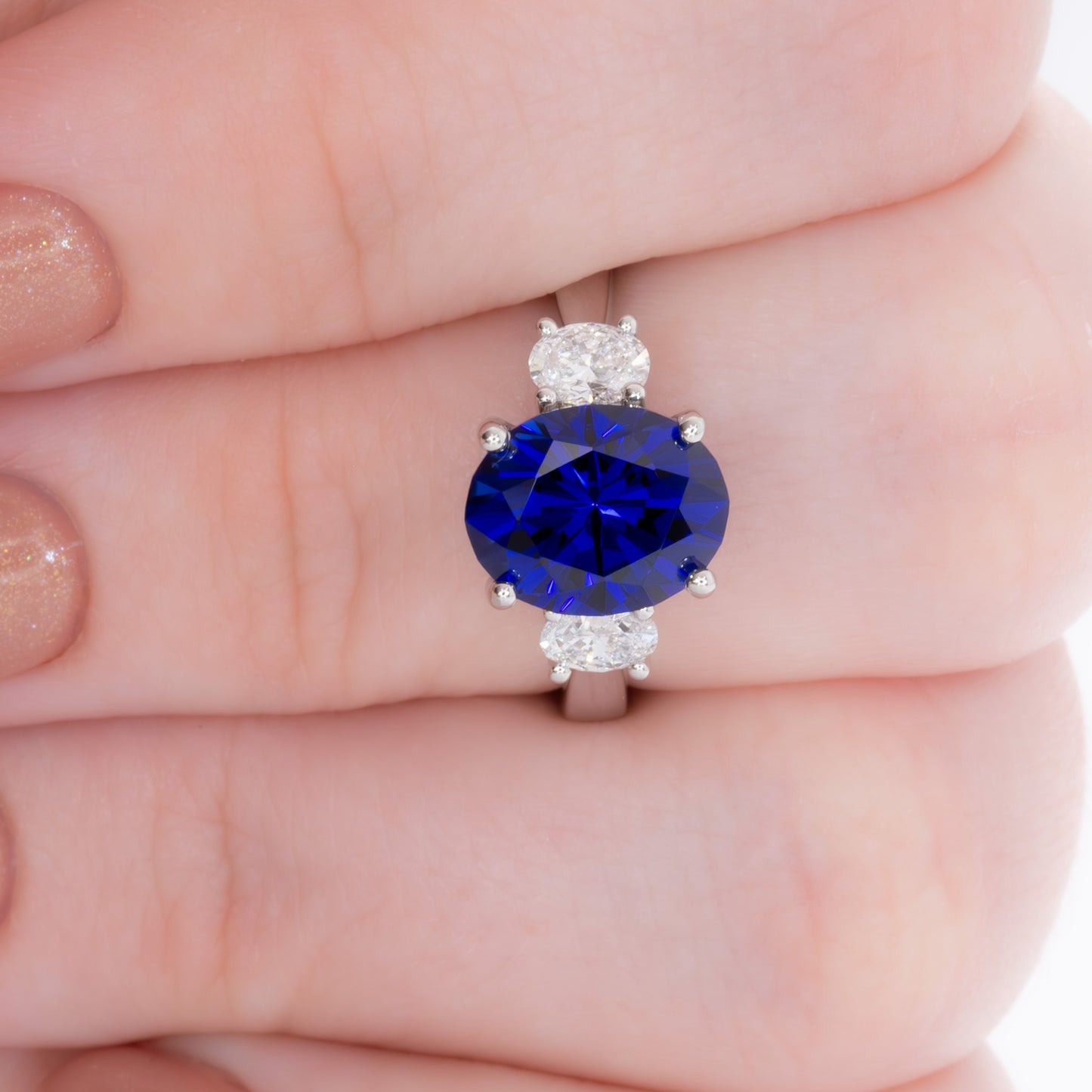 milly three stone engagement ring with oval royal blue lab sapphire