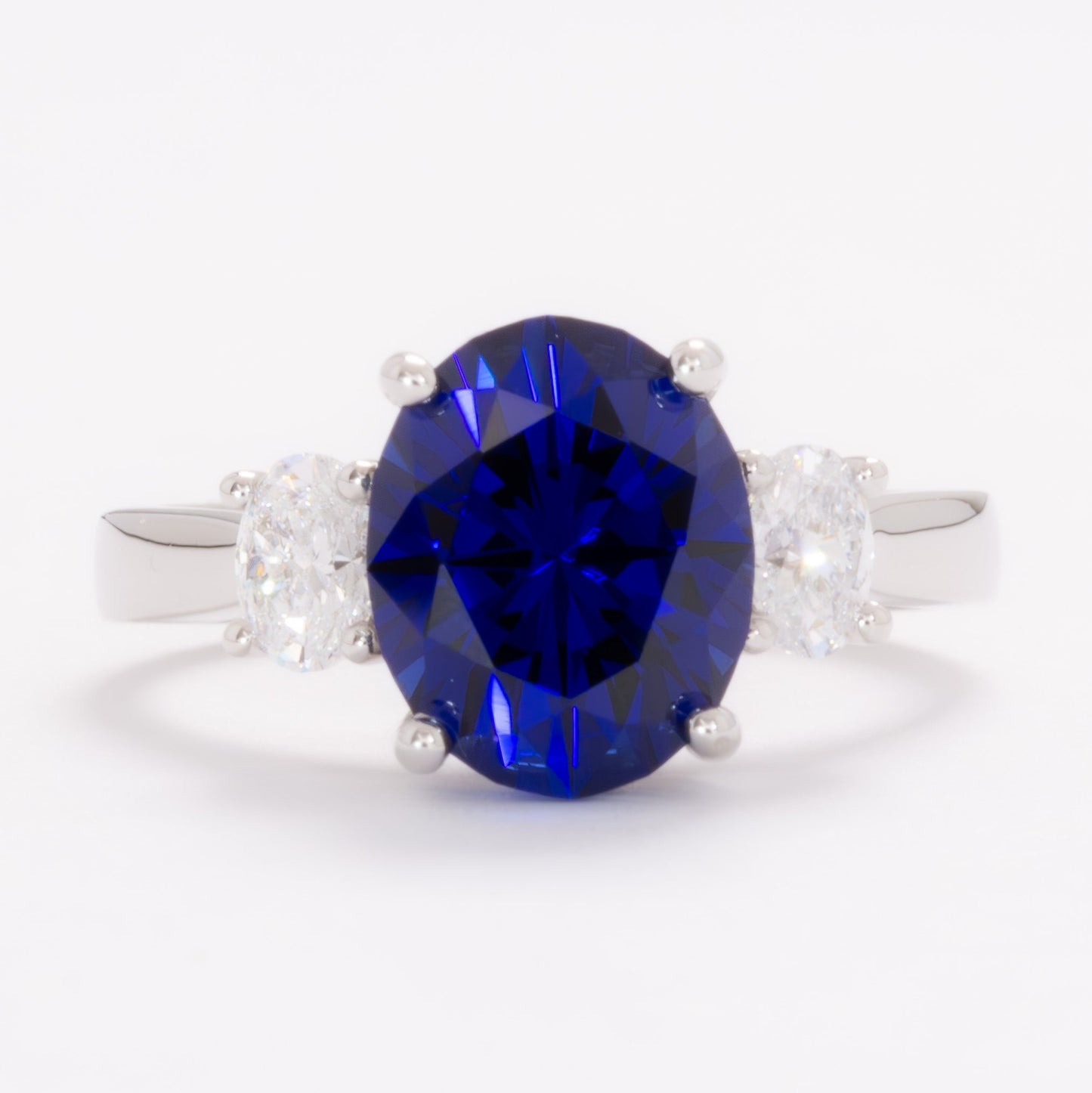 milly three stone engagement ring with oval royal blue lab sapphire