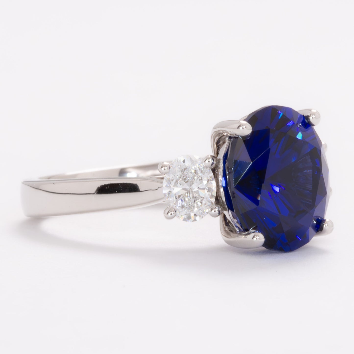 milly three stone engagement ring with oval royal blue lab sapphire