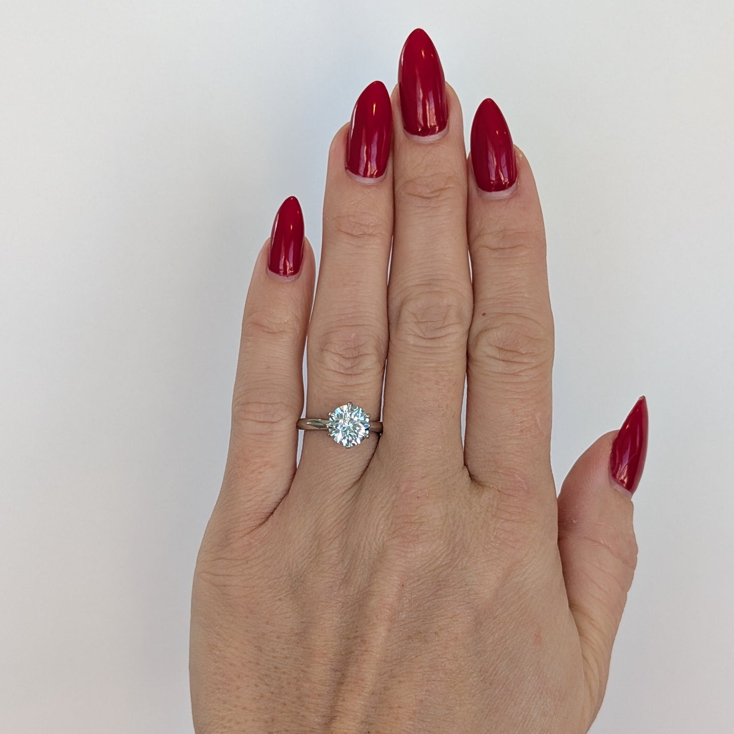 modified charlotte solitaire engagement ring with light blue lab sapphire