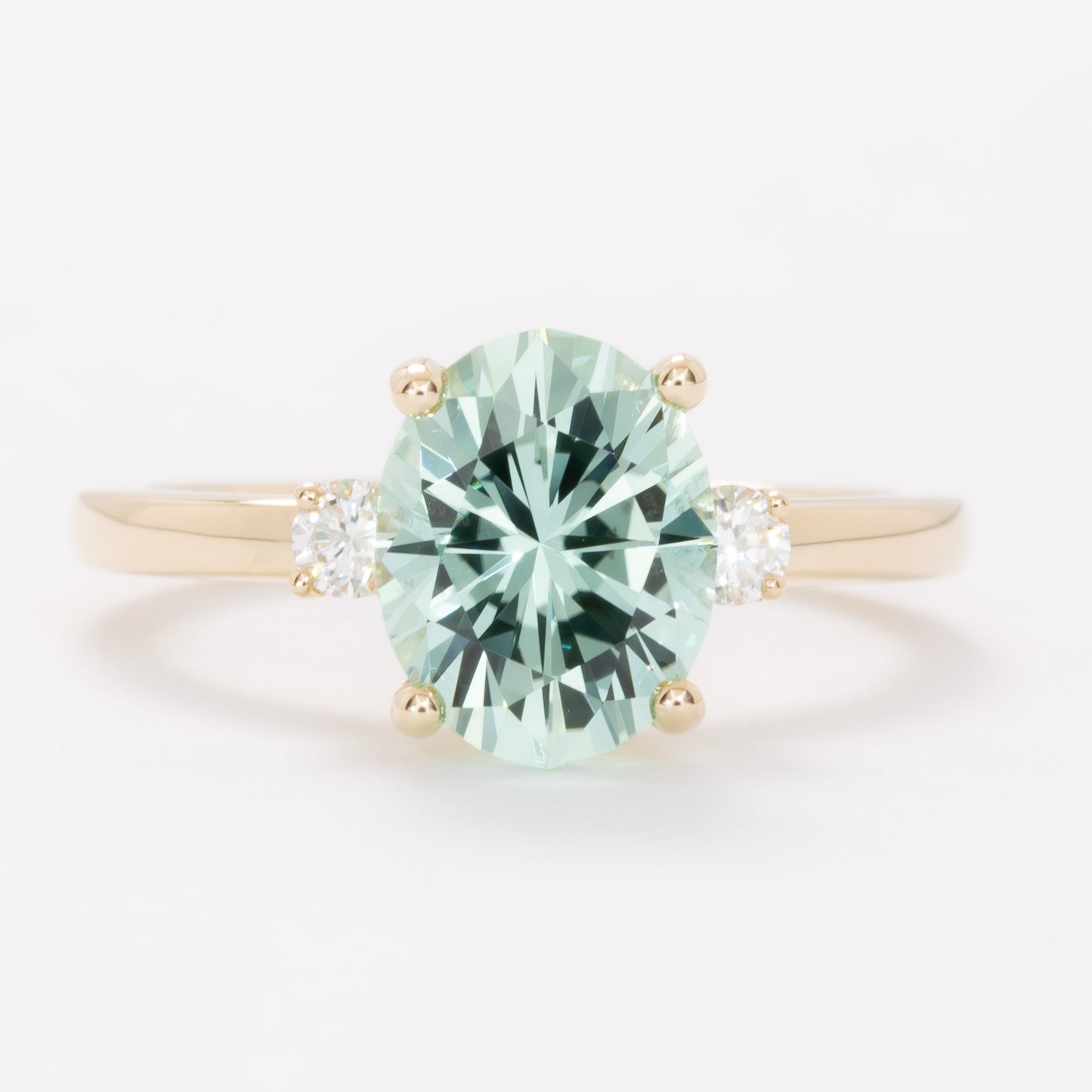 naomi three stone engagment ring with mint oval lab sapphire