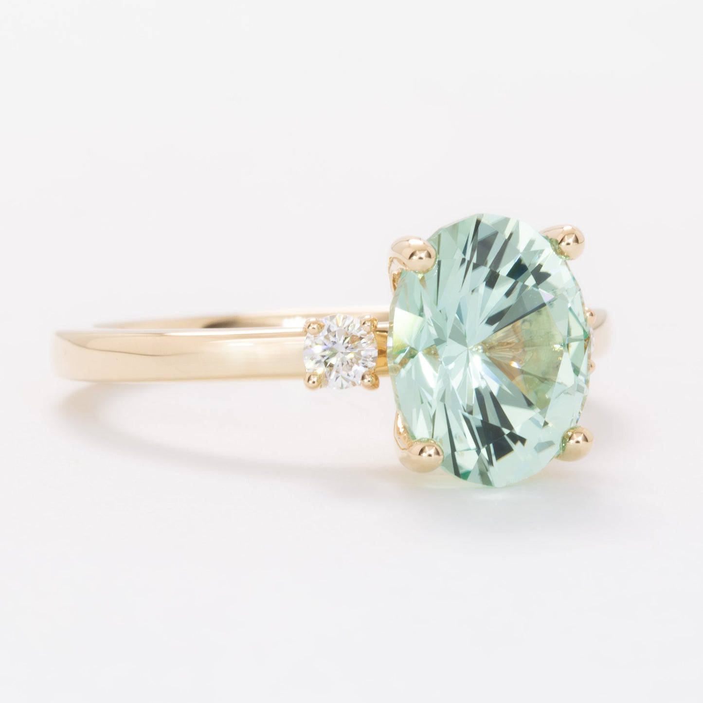 naomi three stone engagment ring with mint oval lab sapphire