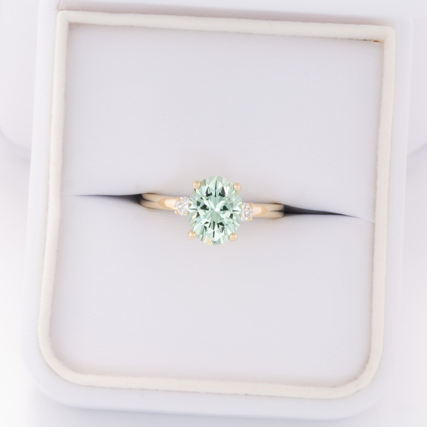 naomi three stone engagment ring with mint oval lab sapphire