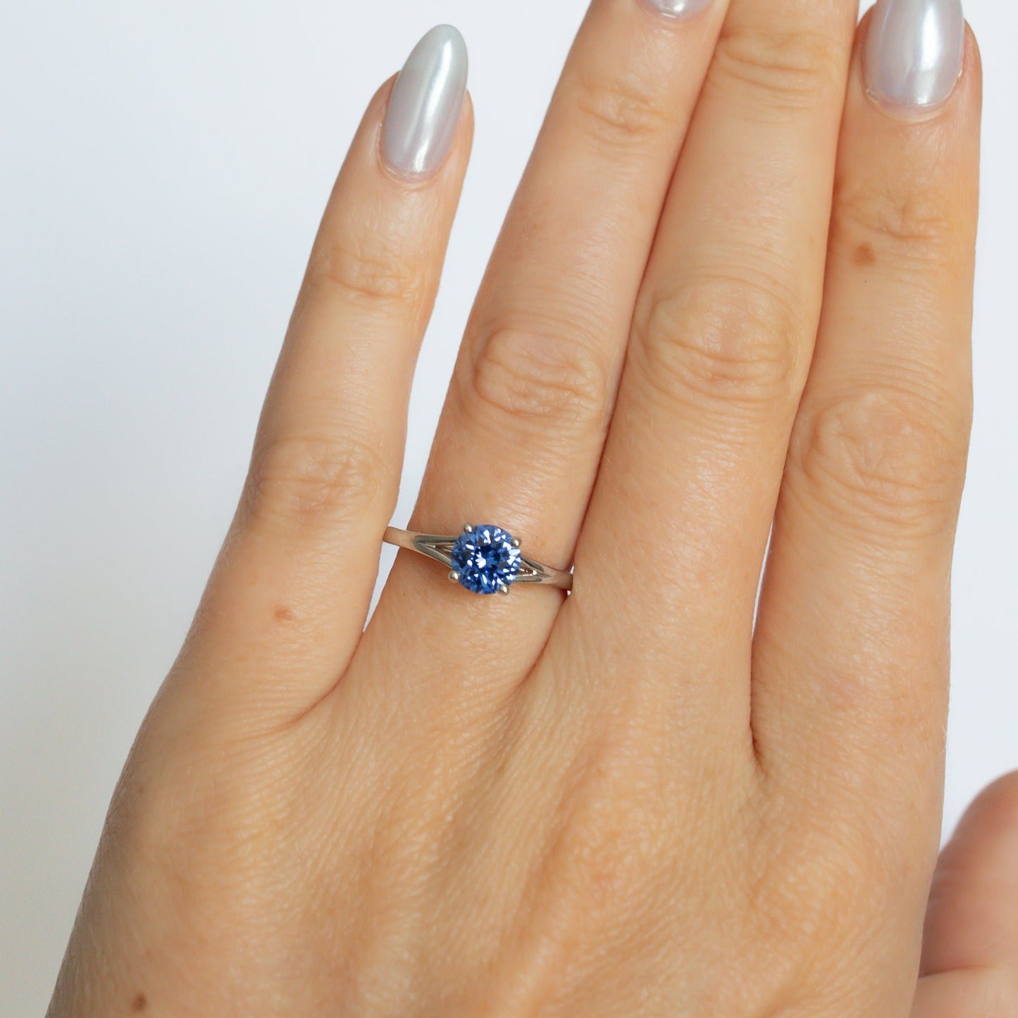 neve engagement ring with blue lab sapphire