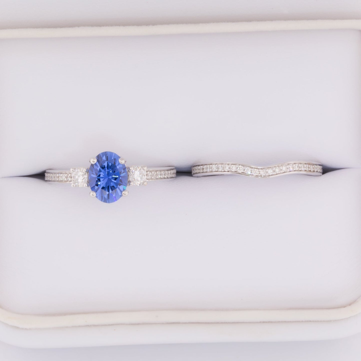 oriane three stone engagement ring with blue oval lab sapphire