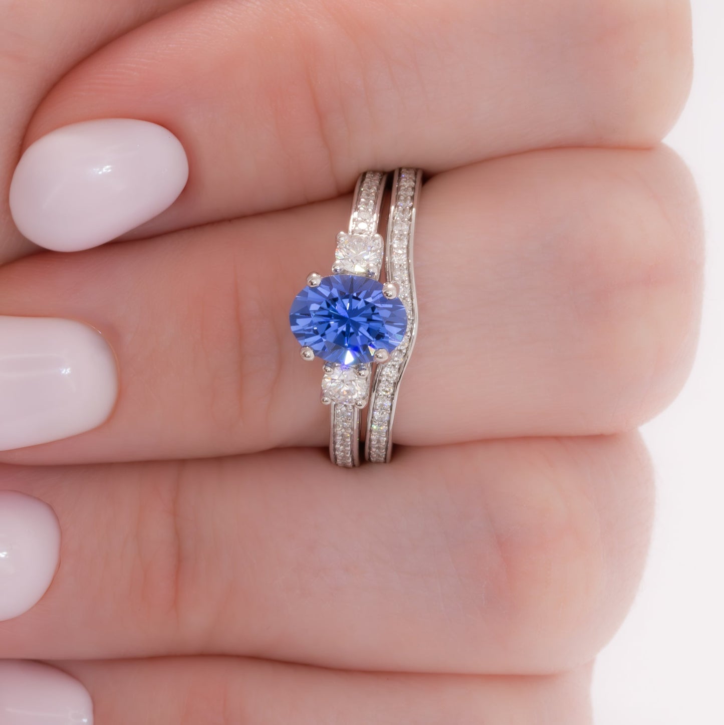 oriane three stone engagement ring with blue oval lab sapphire