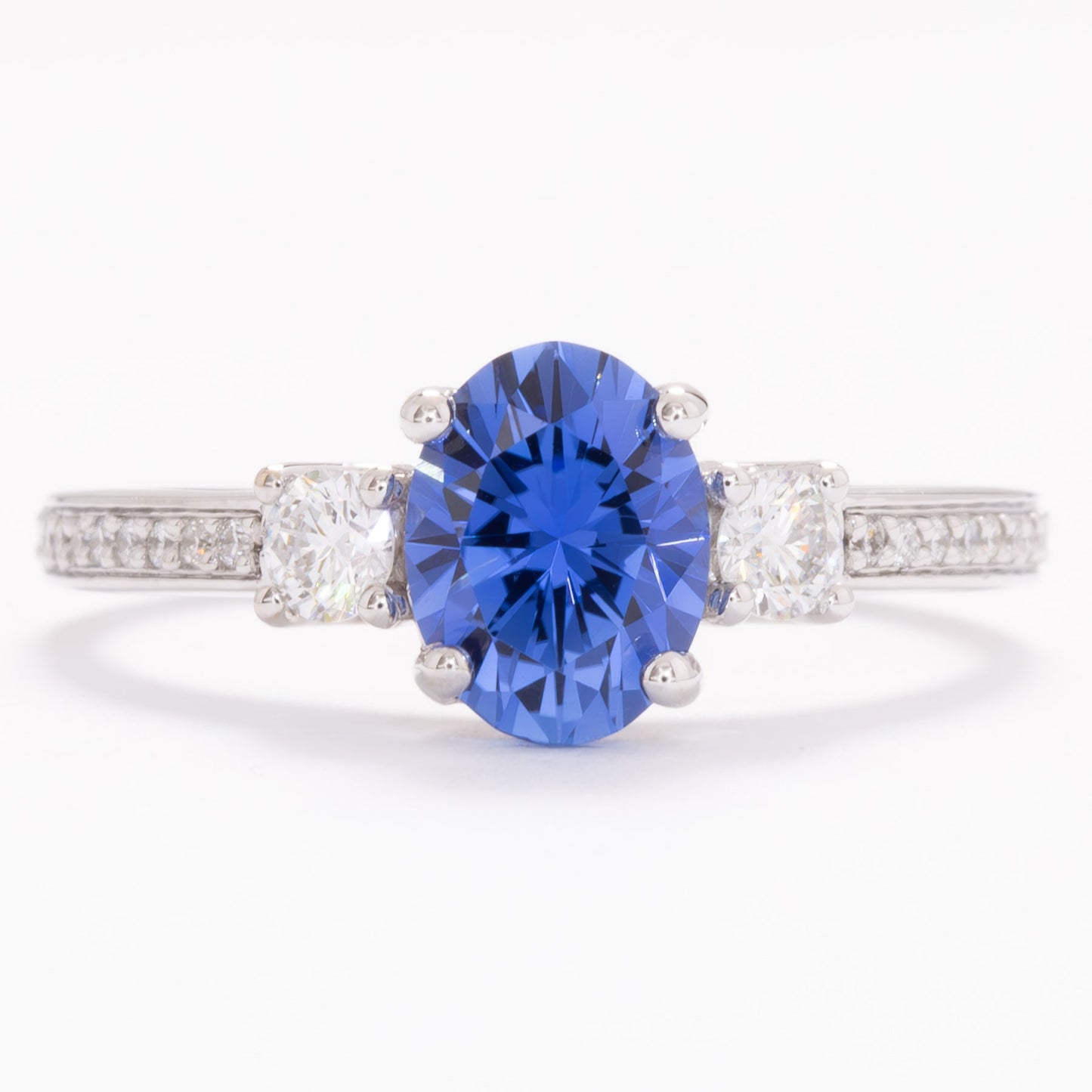 oriane three stone engagement ring with blue oval lab sapphire