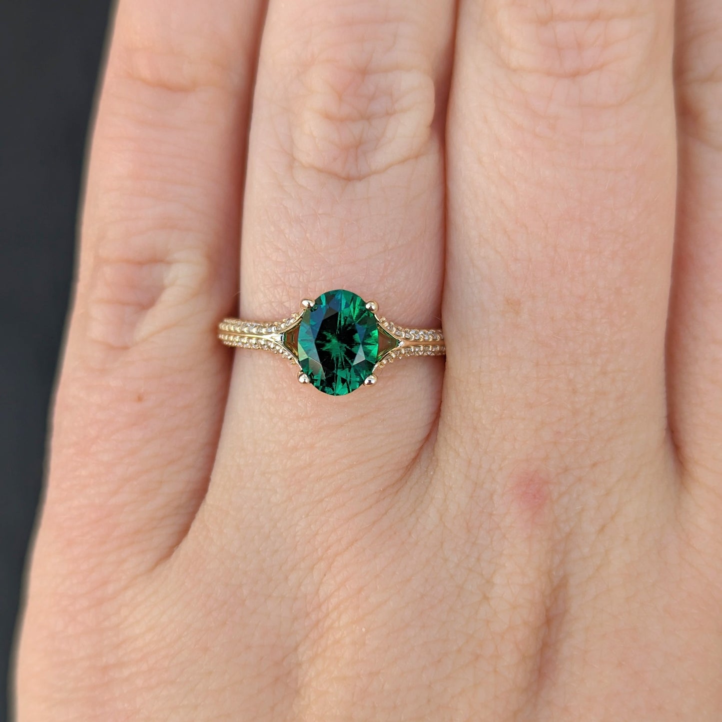 oval lab emerald engagement ring in white gold