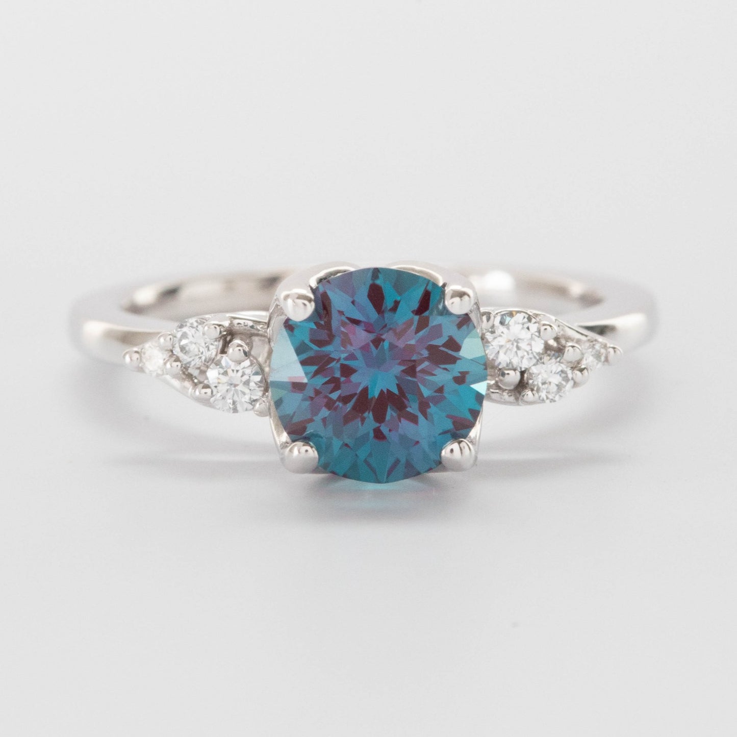 round lab alexandrite in nature inspired engagement ring